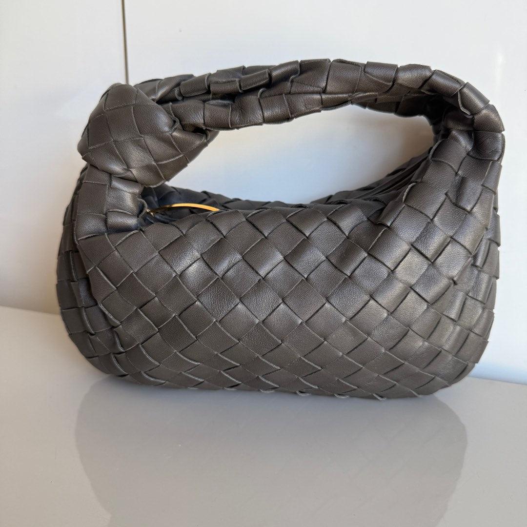 Bottega Veneta Jodie Mini Grey Leather Gold Hardware
 These are professional photos of the actual bag.
 The Bottega Veneta Jodie Mini in Leather offers the perfect balance between practicality and luxury. Its mini size serves as a great everyday