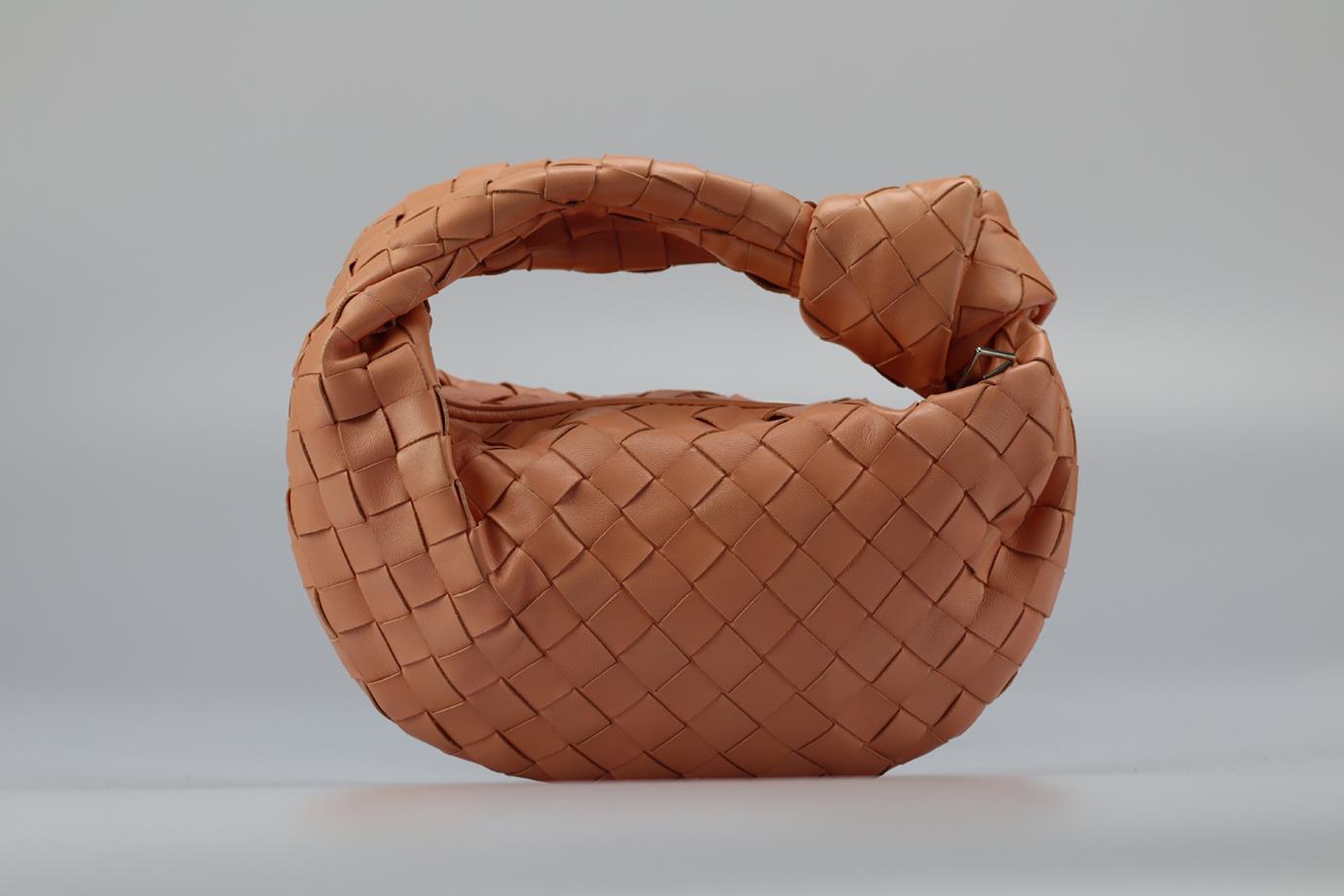 Bottega Veneta Jodie Mini Intrecciato Leather Clutch. Pink. Zip fastening - Top. Comes with - dustbag. Height: 6.1 In. Width: 11.2 In. Depth: 2.5 In. Handle drop: 1.2 In. Condition: Used. Very good condition - Few light marks to exterior material.
