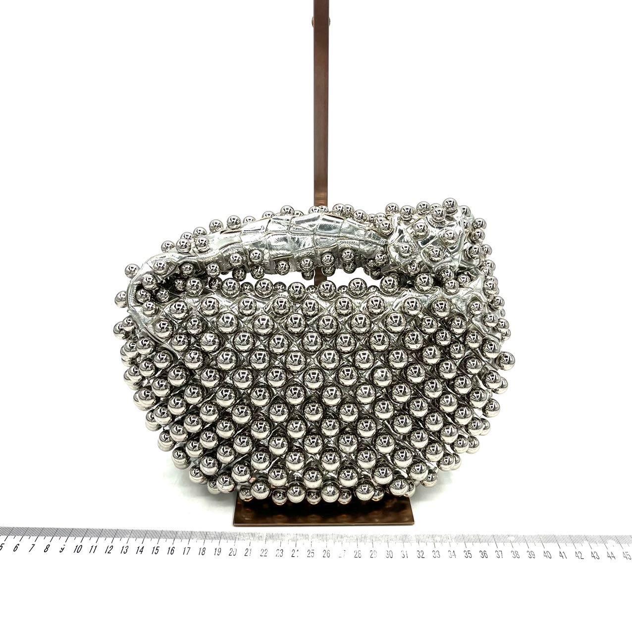 Bottega Veneta Jodie Mini Silver Leather Metallic Studded Rare

The Bottega Veneta Jodie Mini in super rare silver Leather offers the perfect balance between practicality and luxury. Its mini size serves as a great everyday bag, while the iconic