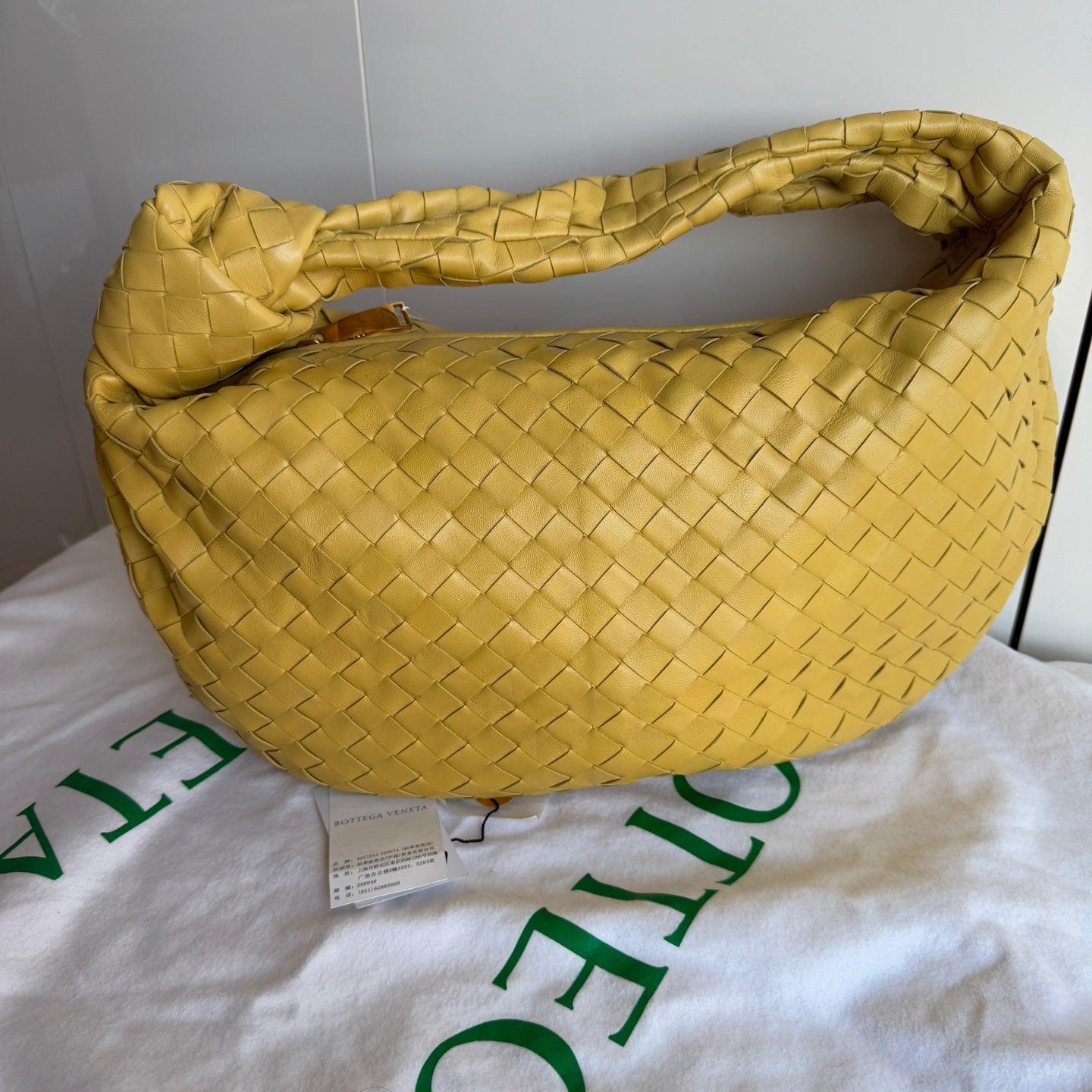 Bottega Veneta Jodie Small Yellow Lambskin Leather
These are professional photos of the actual bag.
The Bottega Veneta Jodie Medium Lambskin Leather offers the perfect balance between practicality and luxury. Its medium size serves as the ideal