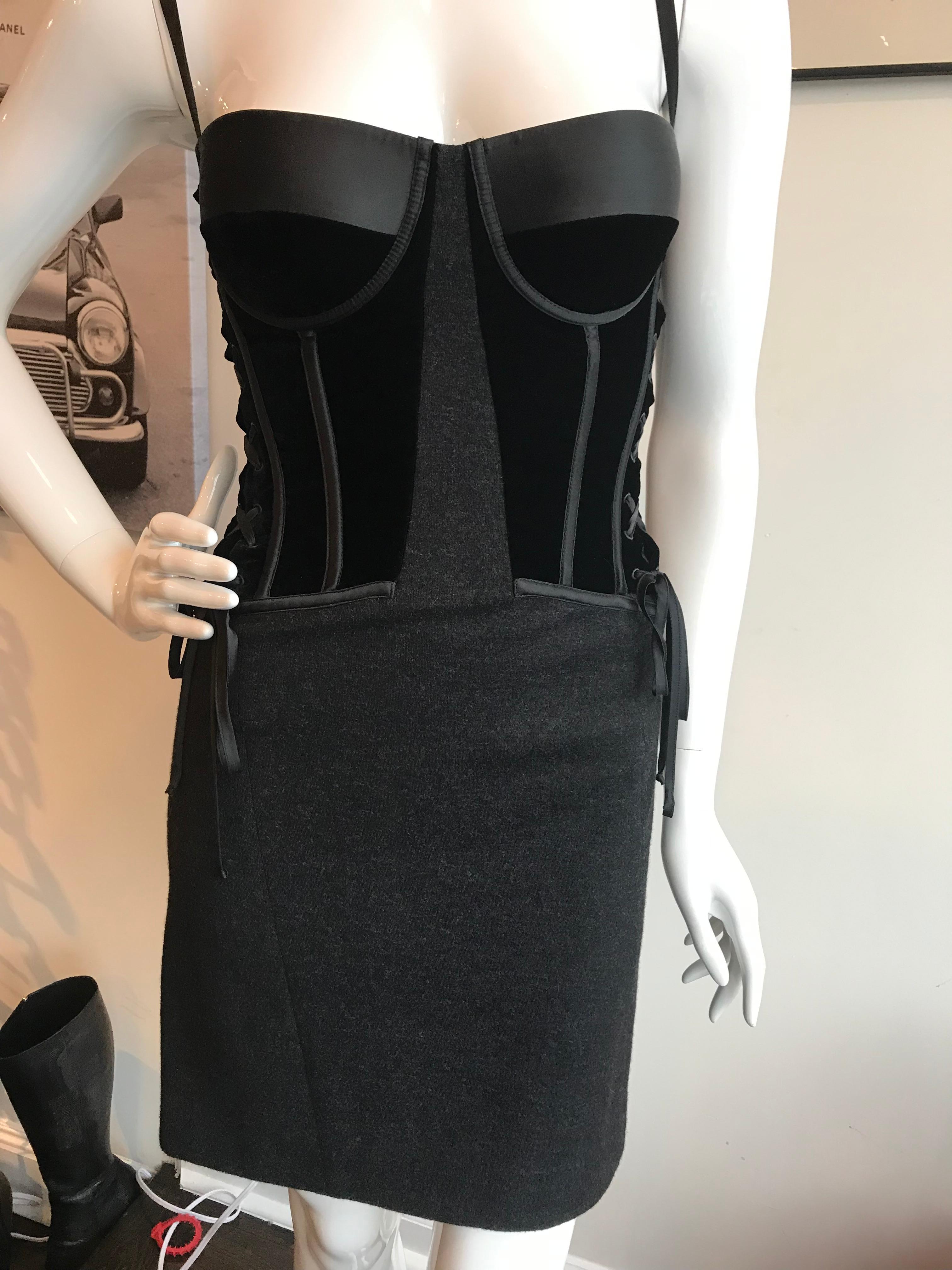 Black and grey knit. Sleeveless mini dress with structured velvet bodice, silk trim, lace-up sides and zip at back.