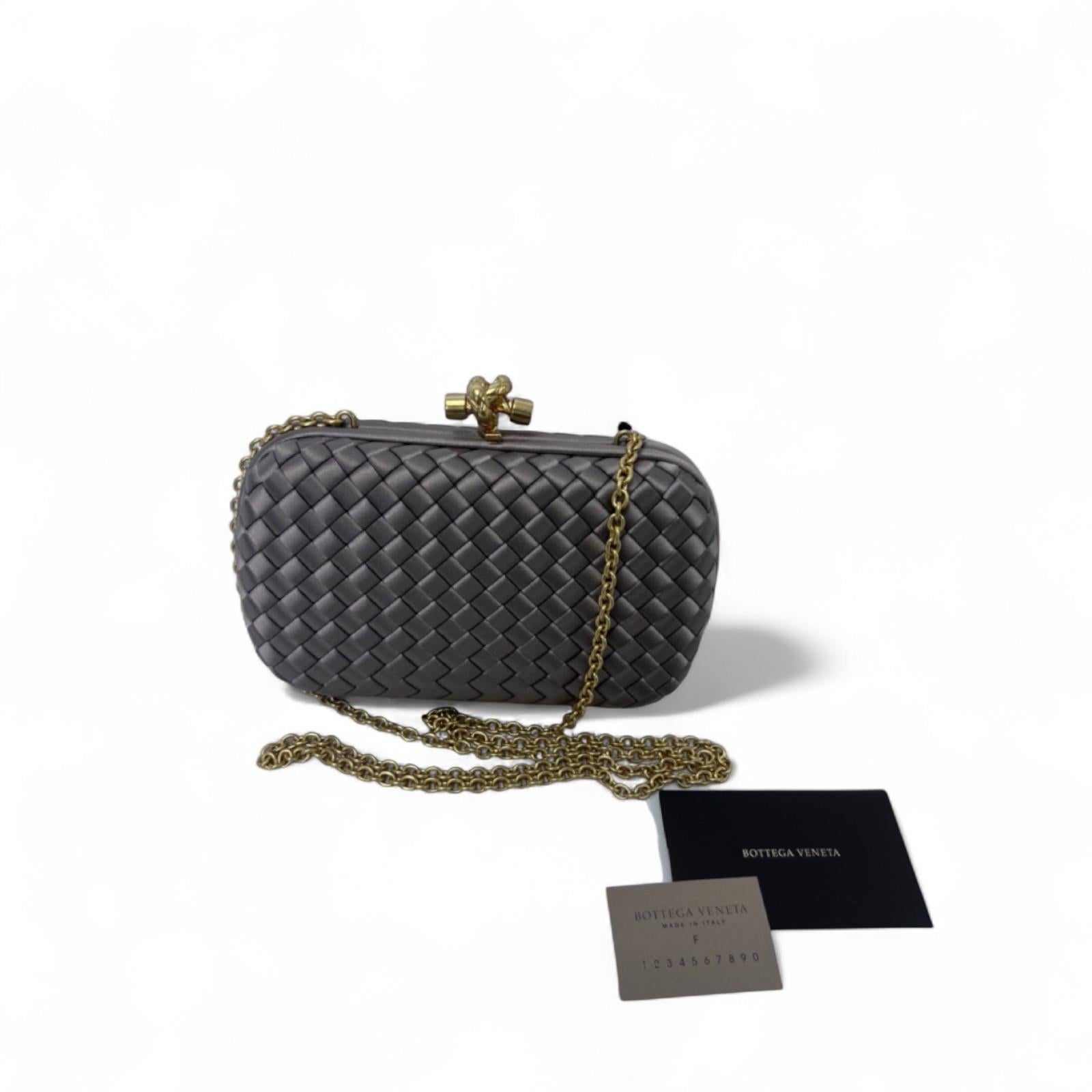 Understated and refined, this Bottega Veneta Knot Clutch is a timeless evening essential that reflects the brand’s commitment to quiet luxury and impeccable craftsmanship.

Crafted in luminous champagne bronze silk, the clutch features the house’s