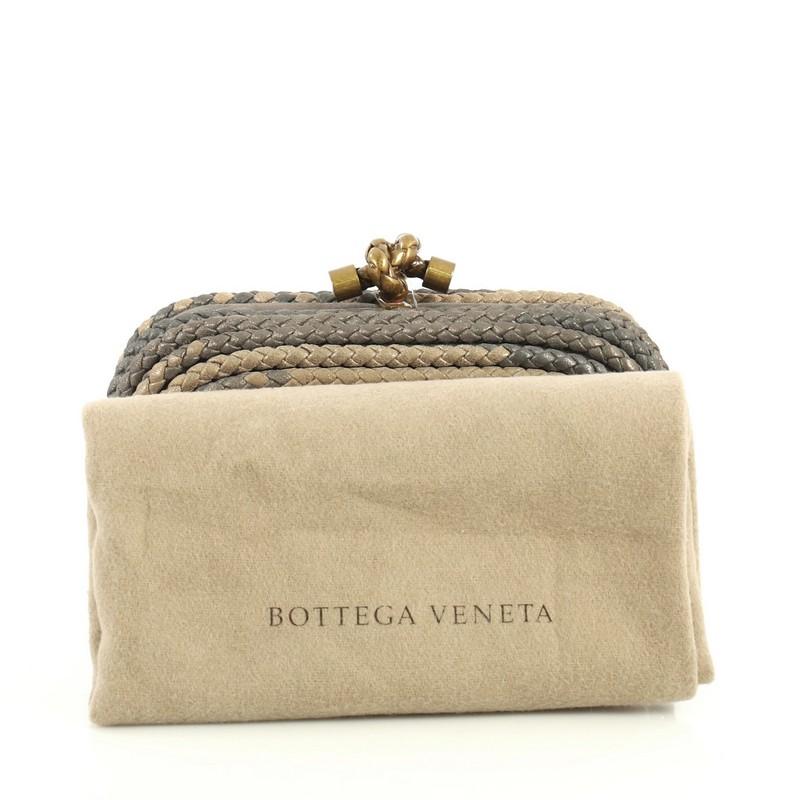 This Bottega Veneta Knot Clutch Braided Leather Small, crafted in neutral and gray braided leather, features aged gold-tone hardware. Its knot clasp closure opens to a metallic gray suede interior.

Estimated Retail Price: $1,150
Condition: