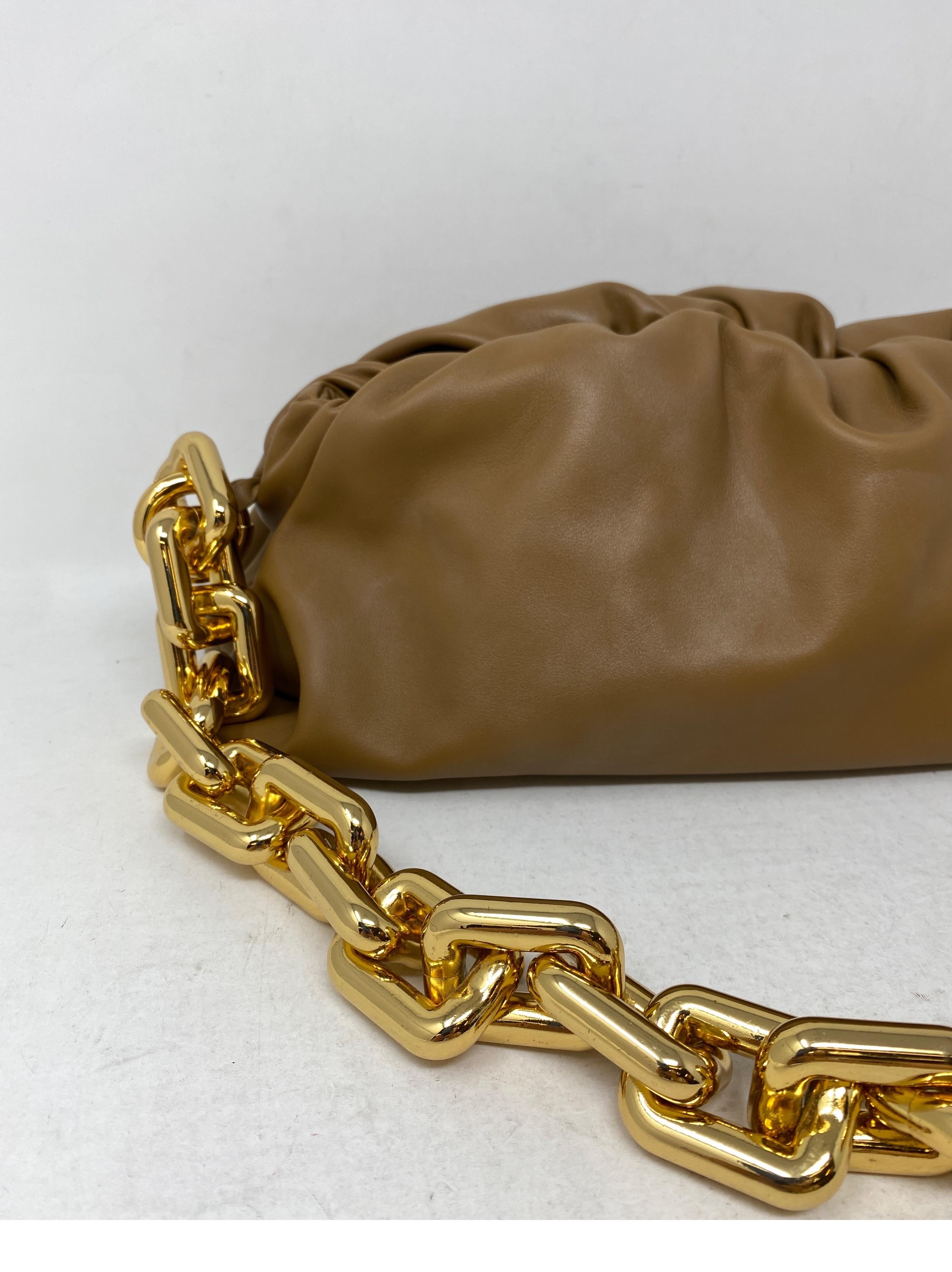 Bottega Veneta Leather Clutch Bag. Tan gold hardware Bottega. Iconic bag. Chunky gold hardware. Nice nuetral color. Leather is known for its quality from Bottega Veneta. The house has become more popular than ever. Can be detached from bag. Mint