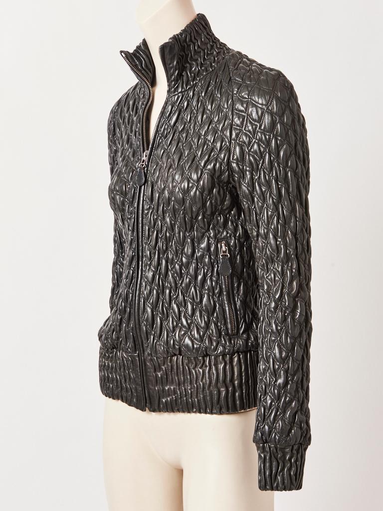 Bottega Veneta, black, leather, quilted, bomber jacket, having a trapunto-like surface with an industrial zipper closure at the center, and vertical zippered side pockets. The quilting stretches to fit a European size 44.