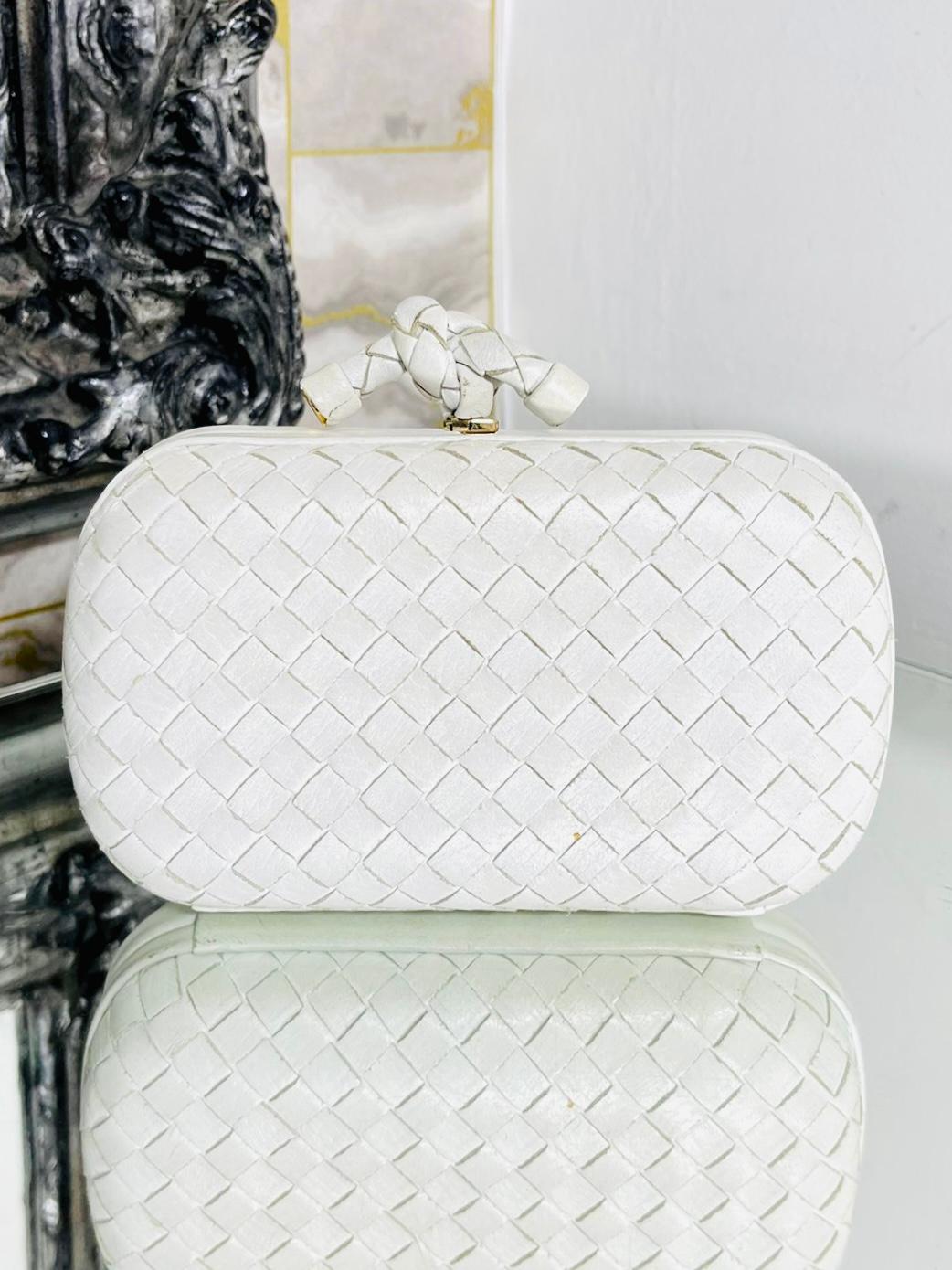 Bottega Veneta Leather Top Knot Clutch Bag

White leather clutch bag designed with the brand's signature Intrecciato weave crafted Featuring signature knot twisted closure with gold engraved logo.

Size – Height 10cm, Width 16cm, Depth