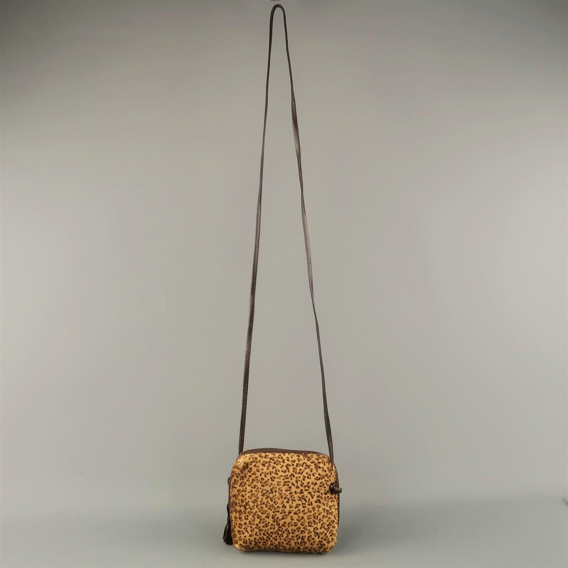 Vintage BOTTEGA VENETA mini crossbody bag comes in leopard print ponyhair in a square shape with top tassel zip and skinny strap. Wear throughout. As-is. Made in Italy.Fair Pre-Owned Condition. 

Measurements: 
  Length: 5 inches Width: 2 inches