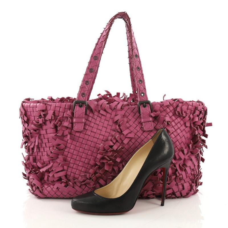 This Bottega Veneta Lido Patchwork Tote Fringe Intrecciato Nappa Large, crafted in purple fringe intrecciato nappa leather, features dual handles with buckle and belt accents, patchwork and frayed fringed detailing, and gunmetal-tone hardware. It