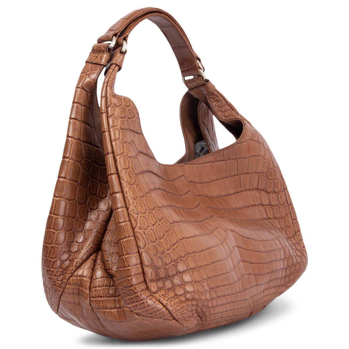100% authentic Bottega Veneta shoulder bag in light brown matte crocodile. Closes with a magnet on top. Lined in off-white suede with a cell phone pocket against the front and a zipper pocket against the back. Has been carried and is in excellent