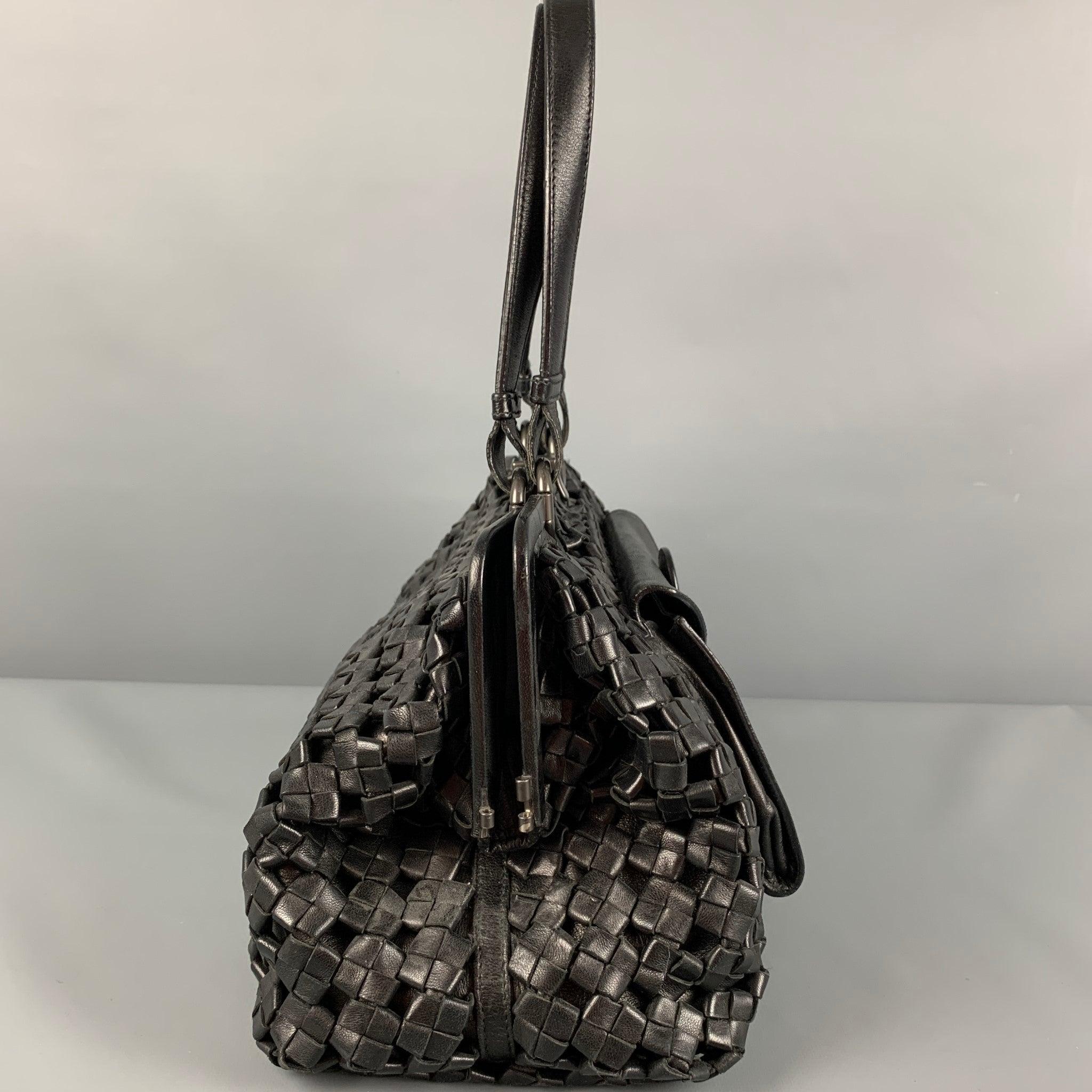 BOTTEGA VENETA 'Limited Edition' bag comes in a black woven leather featuring a satchel style, front pocket detail, top handles, inner pocket, and a top clasp closure. Made in Italy.
Very Good
Pre-Owned Condition. 

Marked:   13498 031/250