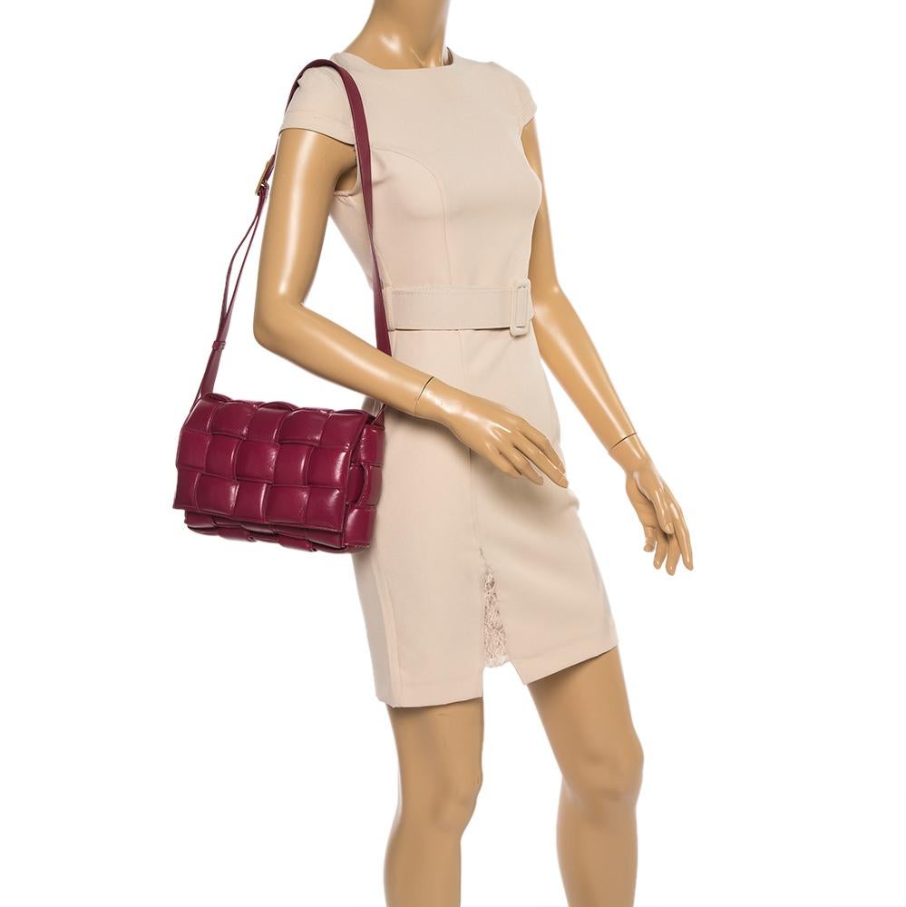 The current bag on many fashionista's minds is this Cassette bag from the house of Bottega Veneta. We have here the one in magenta leather, flaunting a padded maxi weave and a shoulder strap. The insides are sized to fit your phone and other little