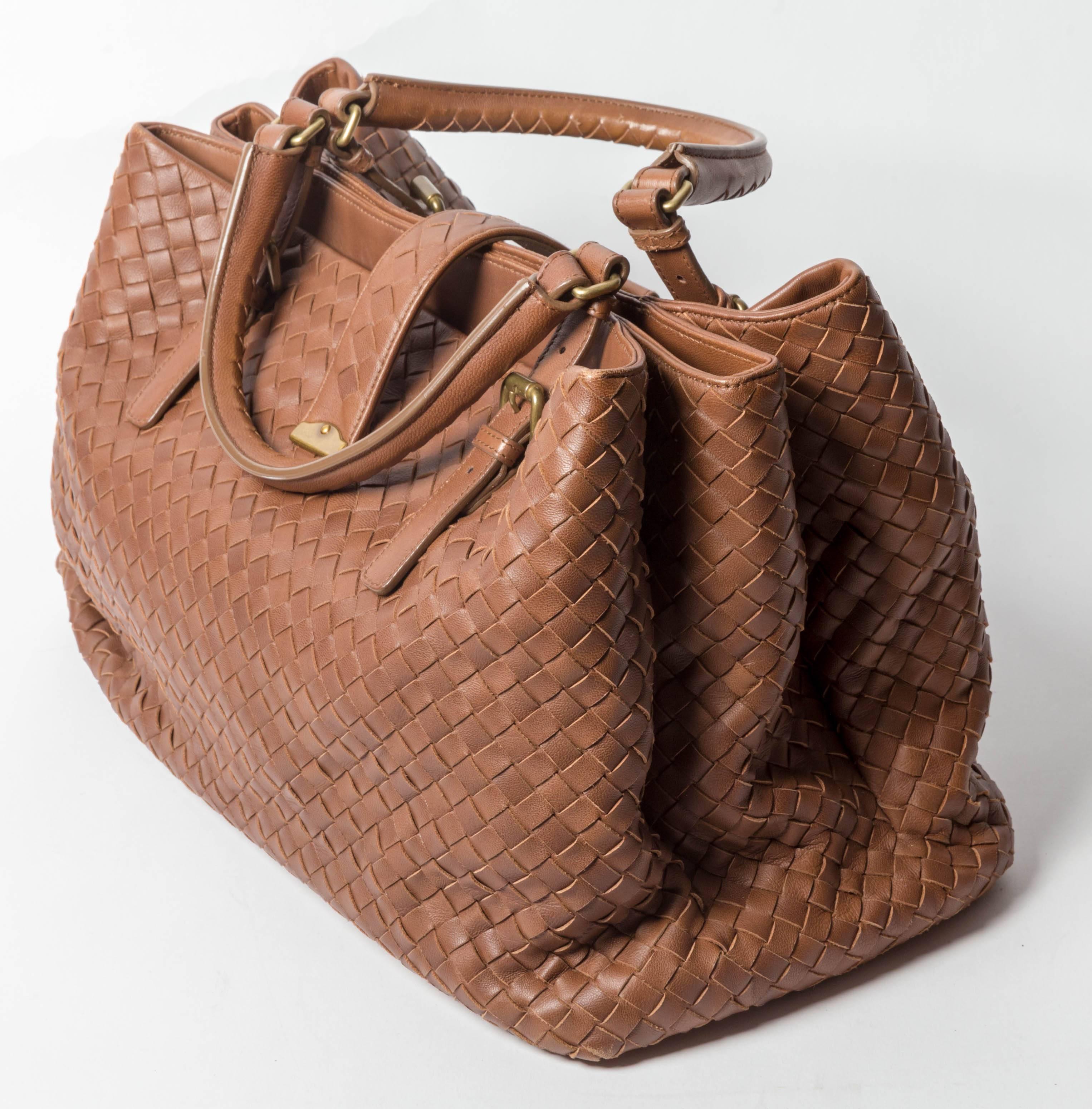 Hand woven brown  Intrecciato leather Bottega Veneta Medium Roma satchel with gold-tone hardware, rolled top handles, tonal suede lining, single zip pocket at interior wall, three spacious compartments (one with snap closure)  and push-lock closure