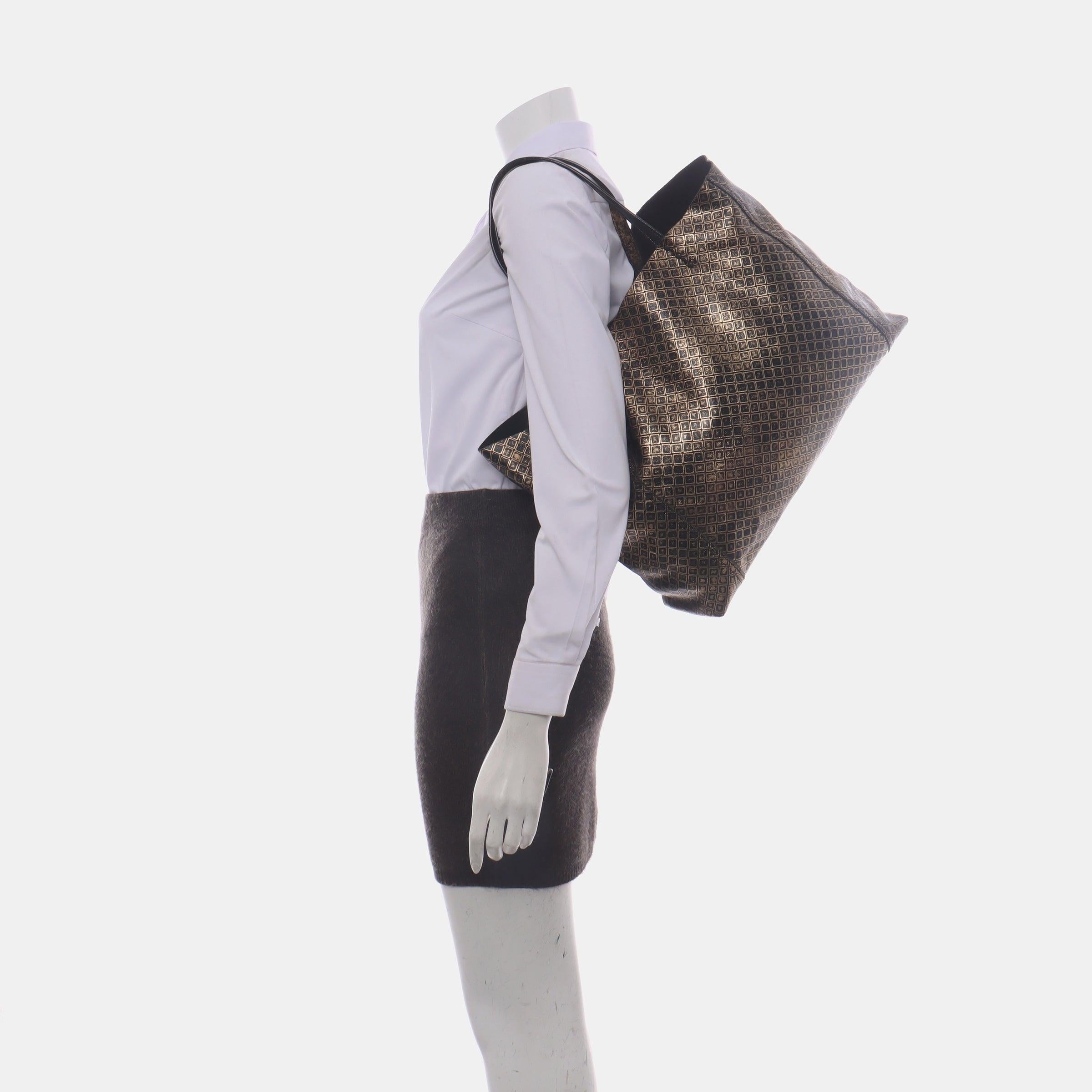 Bottega Veneta Metallic Black Gold Intrecciomirage Leather Tote Bag
 These are professional photos of the actual bag.
 CONDITION: VERY GOOD
 Some crease lines. Rubbing around corners, edges, shoulder strap. 
 DETAILS: 
 
 Bottega Veneta
 Veneta
 
