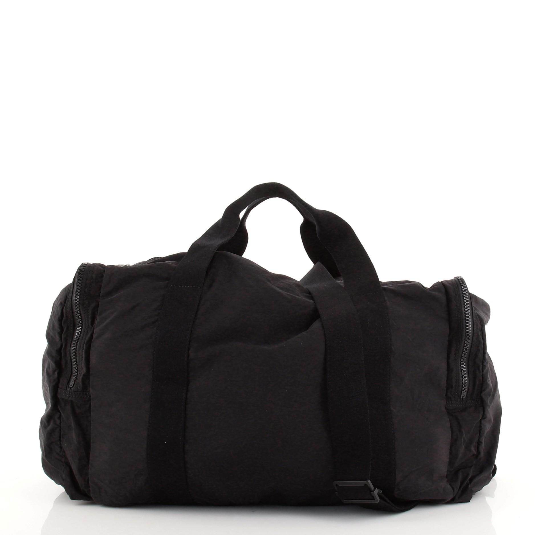 Bottega Veneta Multi Pocket Duffle Nylon with Intrecciato Nappa Large. Slight odor in interior. Creasing, light wear and marks on exterior and in interior, loss of shape on front trim, cracking on front trim wax edges. Wear on handles and strap,