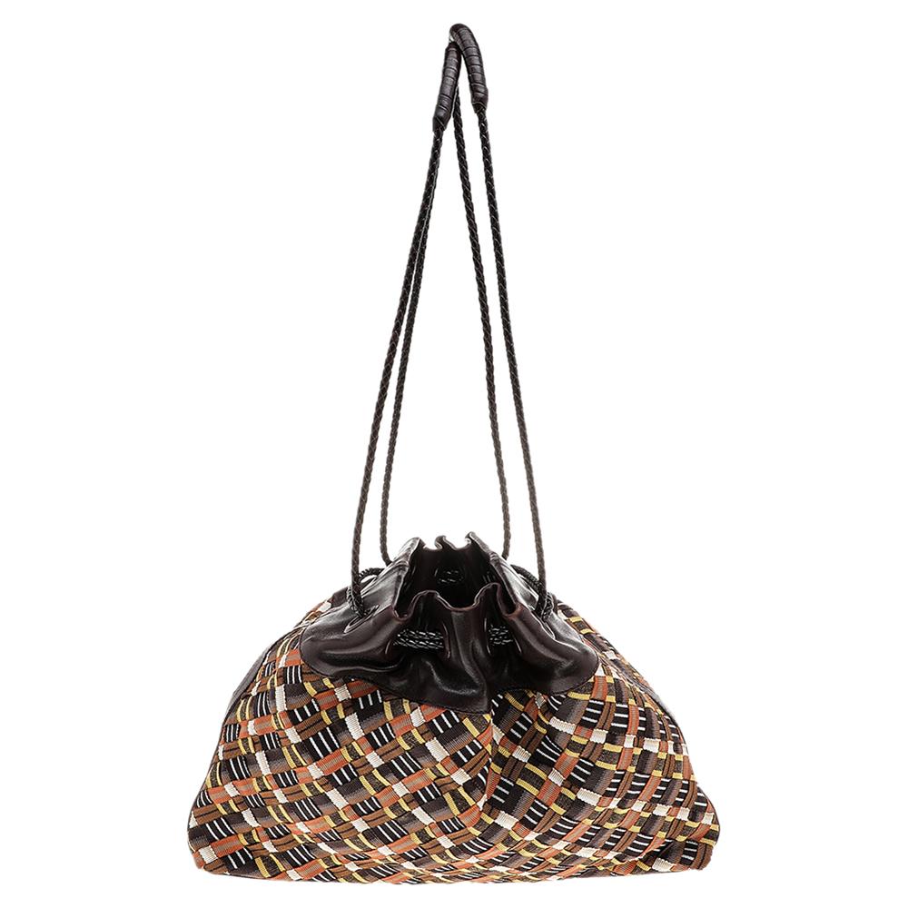 This shoulder bag from Bottega Veneta is truly a modern piece that you can own. It is designed using multicolored fabric and leather on the exterior with drawstring detailing and gold-toned hardware. Carry your daily essentials in this super-chic,
