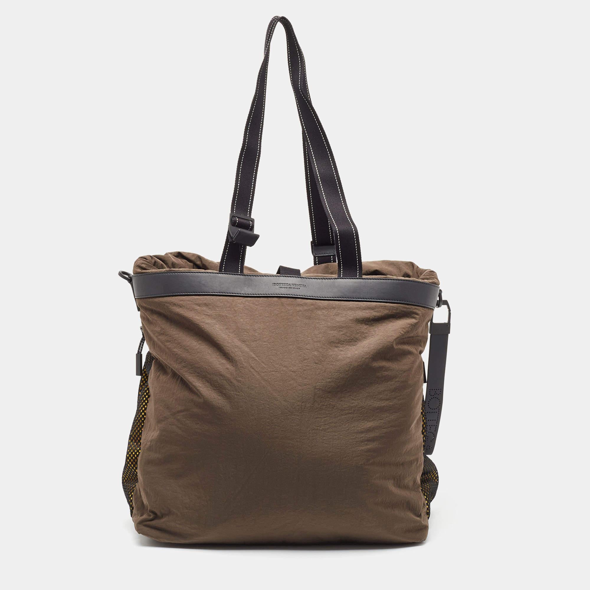 The Bottega Veneta Paper Touch Fold Over Tote exudes contemporary elegance with its vibrant hues and innovative material. Crafted with luxurious nylon featuring a paper-like texture, it offers a spacious interior and a stylish fold-over design,