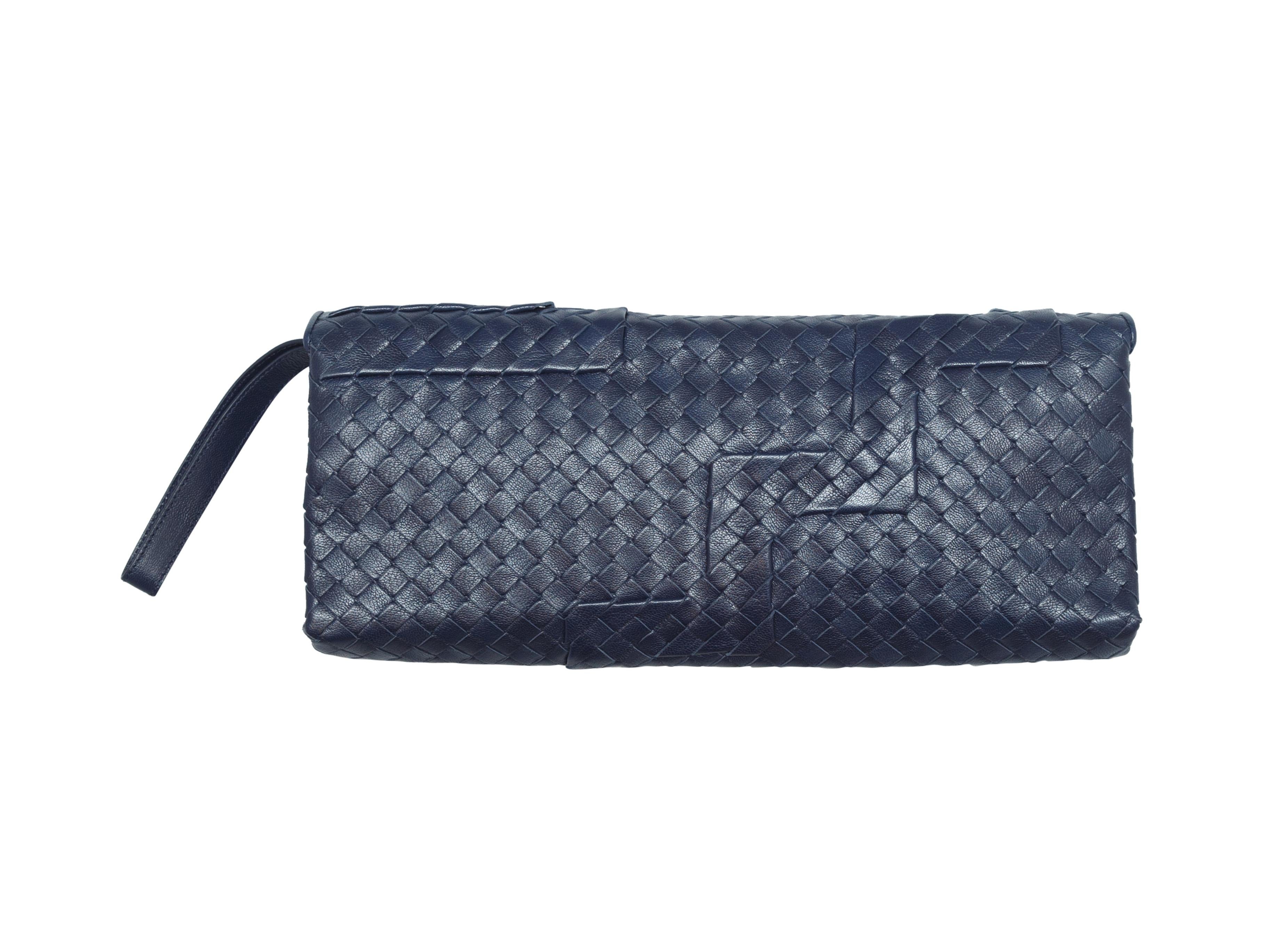 Product details: Navy Intrecciato leather rectangular clutch by Bottega Veneta. Wrist strap at side. 13