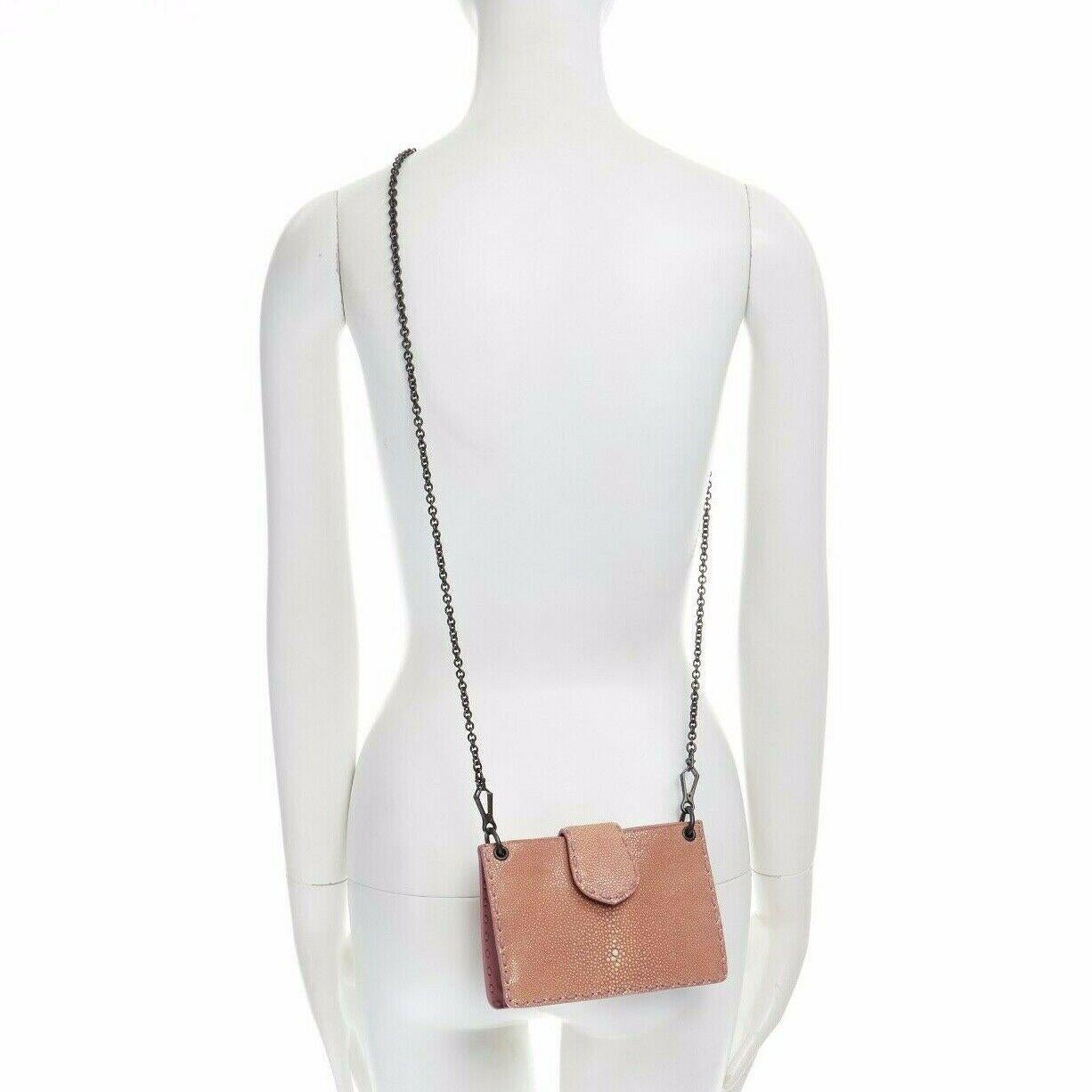 BOTTEGA VENETA nude blush sting ray leather button tab metal chain pouch bag

BOTTEGA VENETA
Genuine stingray leather. Blush pink. Mauve purple leather stitching detail along edges. Top flap closure with magnetic button. Mauve leather lining. Dark