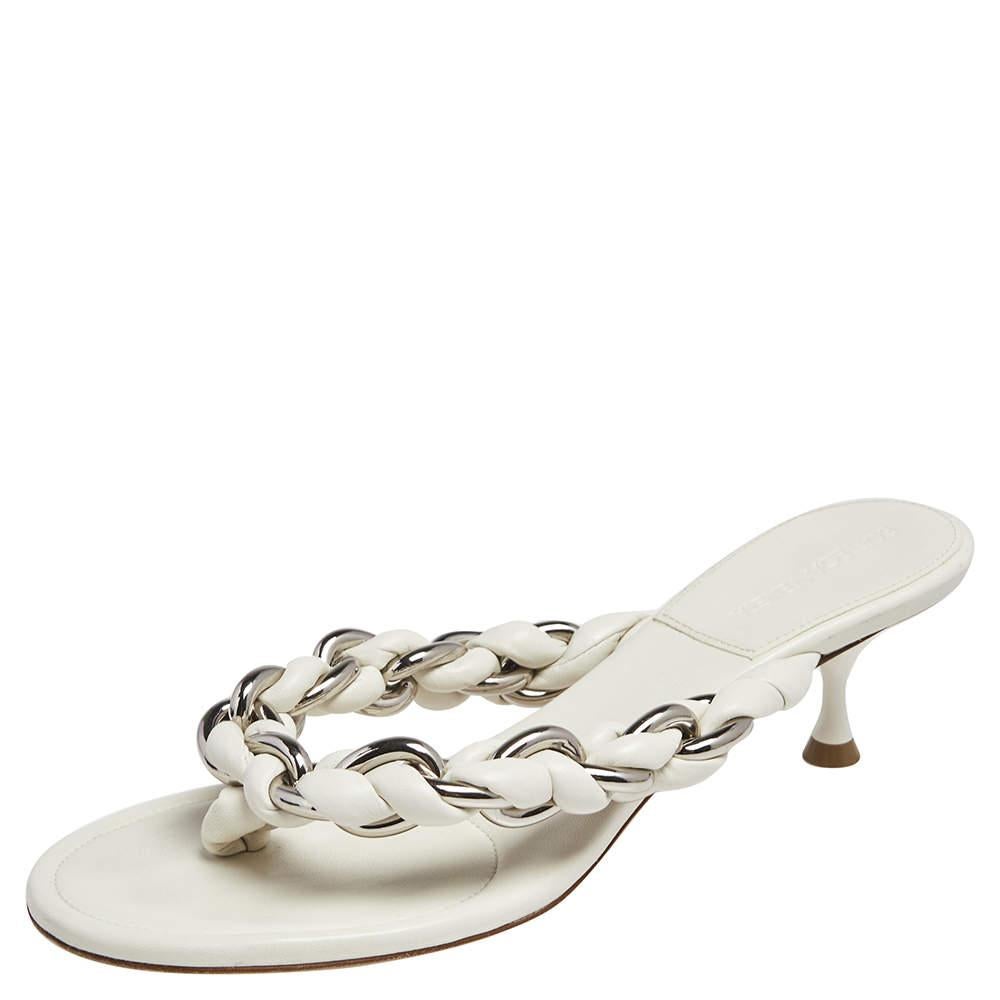 Highlighted by chain-leather braided straps to hold each foot, these Bottega Veneta thong sandals offer fashionable ease beautifully. They are lined with leather and lifted on kitten heels.

