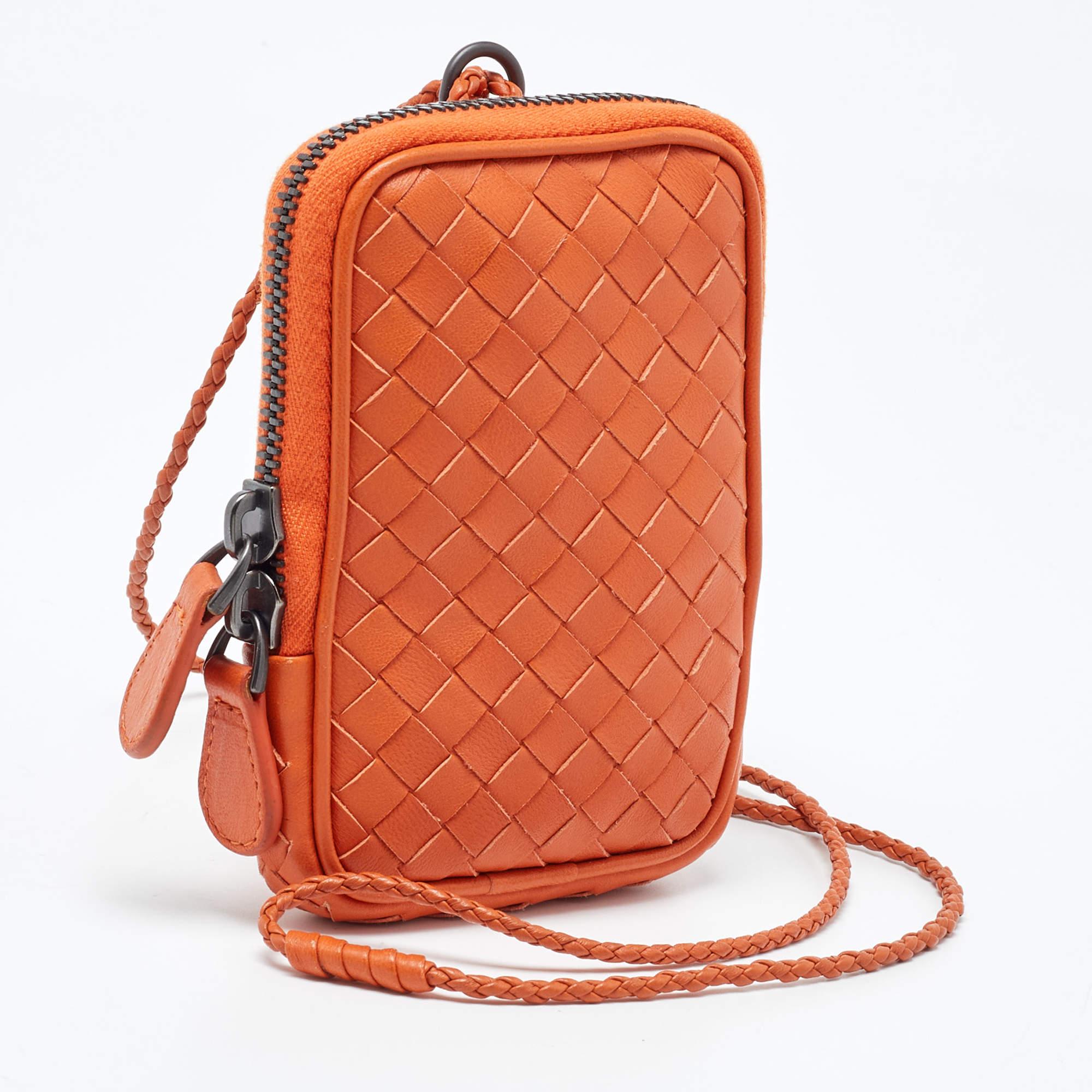 The Bottega Veneta pouch is a luxurious accessory crafted from high-quality leather. It features the brand's signature woven pattern, a secure zip closure, and a spacious interior for organizing essentials. This elegant pouch exudes sophistication