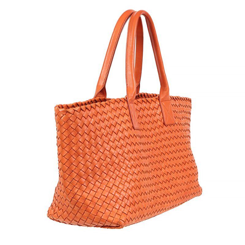 Bottega Veneta 'Small Cabat' in pumpkin orange woven leather. Unlined with a zipper pouch on a string. Has been carried and is in excellent condition. 

Height 24cm (9.4in)
Width 40cm (15.6in)
Depth 17cm (6.6in)
Drop of the Handle 19cm (7.4in)