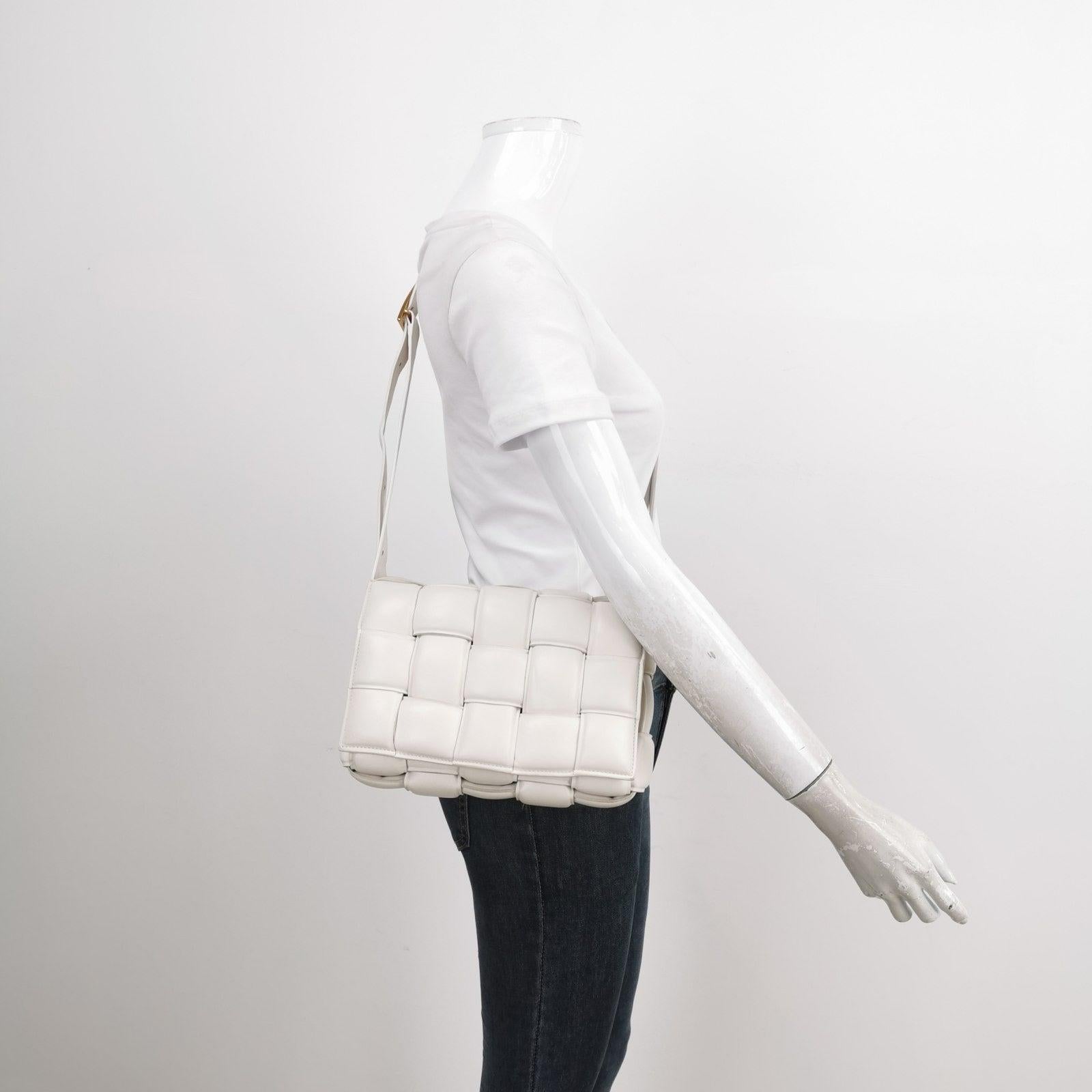 Bottega Veneta Padded Cassette White Leather Crossbody Bag These are professional photos of the actual bag offered by Luxbags. Discover the luxurious craftsmanship of Bottega Veneta with this handwoven leather Padded Cassette shoulder bag. Boasting