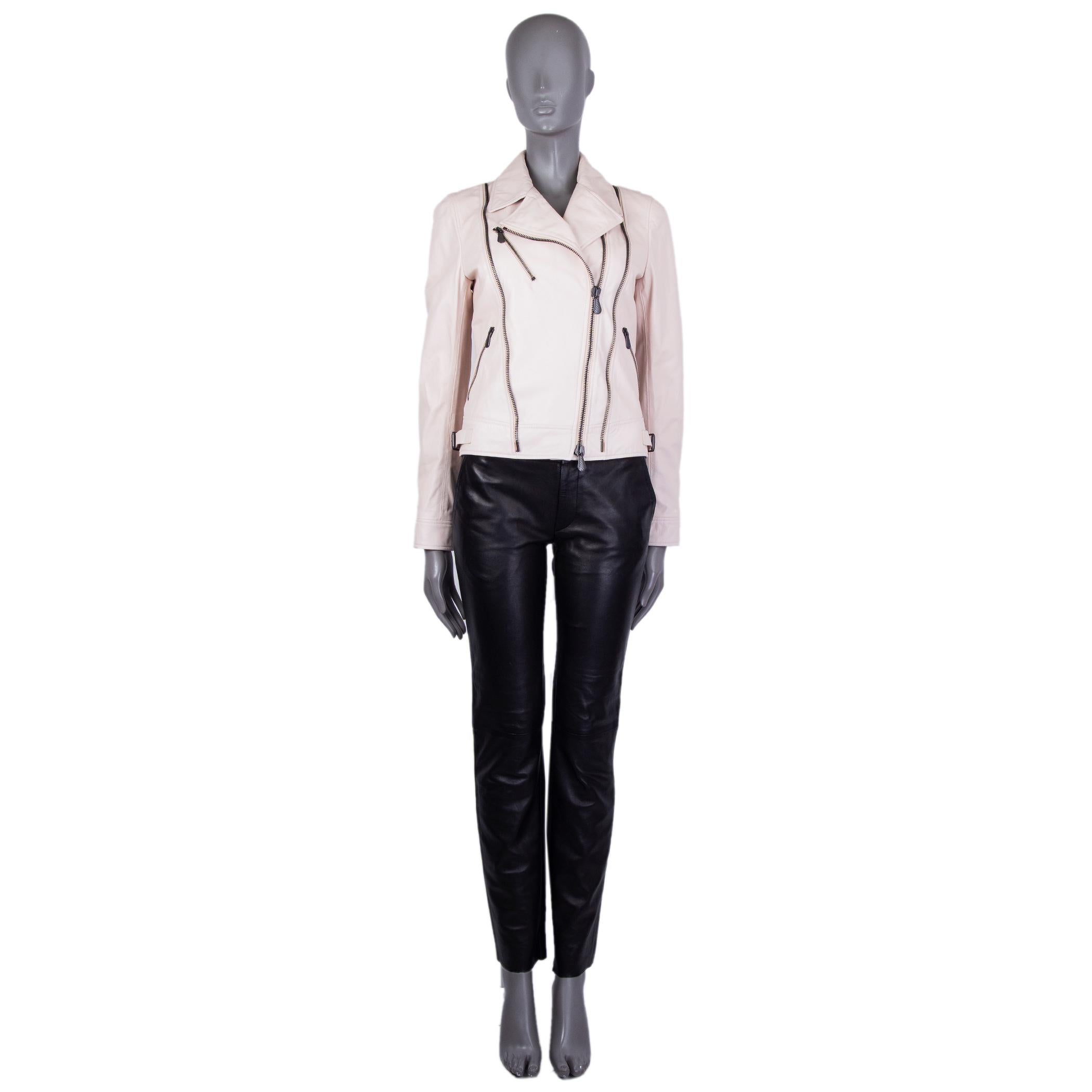 authentic Bottega Veneta biker jacket in pale nude leather. With notch collar, pleated shoulders, three zipper pockets on the fornt, one-button cuffs, cinching belts on the sides of the hem, and quilted lower back. Closes with two-way brass zipper