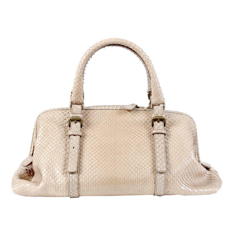 Bottega Veneta Doctors bag in pale taupe (faint green undertone) snakeskin. Closes with a zipper on top. Lined in pink suede with a cell phone pocket against the front and a zipper pocket against the back. Has been carried and is in virtually new