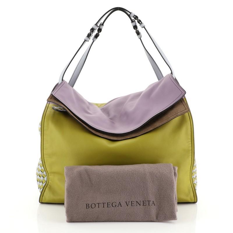This Bottega Veneta Palio Fold Over Tote Colorblock Nappa Leather With Intrecciato Detail, crafted in green color-blocked nappa leather embellished with checkered intrecciato panels, features sliding shoulder strap that doubles over to carry the bag