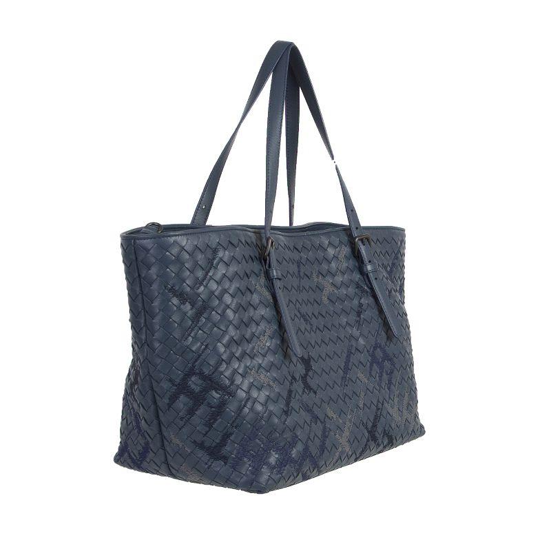 Bottega Veneta 'Denim Intrecciato Nappa Cesta Medium' shopper in petrol blue woven leather with grey and navy blue hand-embroidered graffiato pattern stitching details. Closes with a dog-hook on top. Lined in taupe suede with a small open pocket