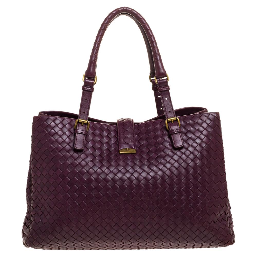 This Bottega Veneta tote is a creation that brings joy to one's sight! It has been beautifully crafted from leather in their signature Intrecciato pattern and is held by two top handles. The bag is also equipped with a flap lock which secures three