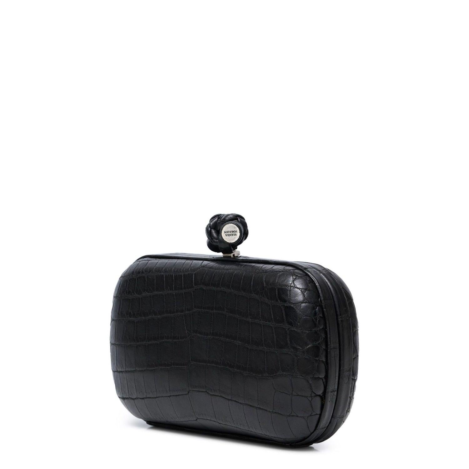 - Black
- Leather
- Knot detailing
- Kiss-lock fastening
- Main compartment
- Internal logo stamp
- Comes with dust bag
Condition: Good
This pre-loved bag is in good condition, with some stains to the lining and visible wear and slight scuffing to