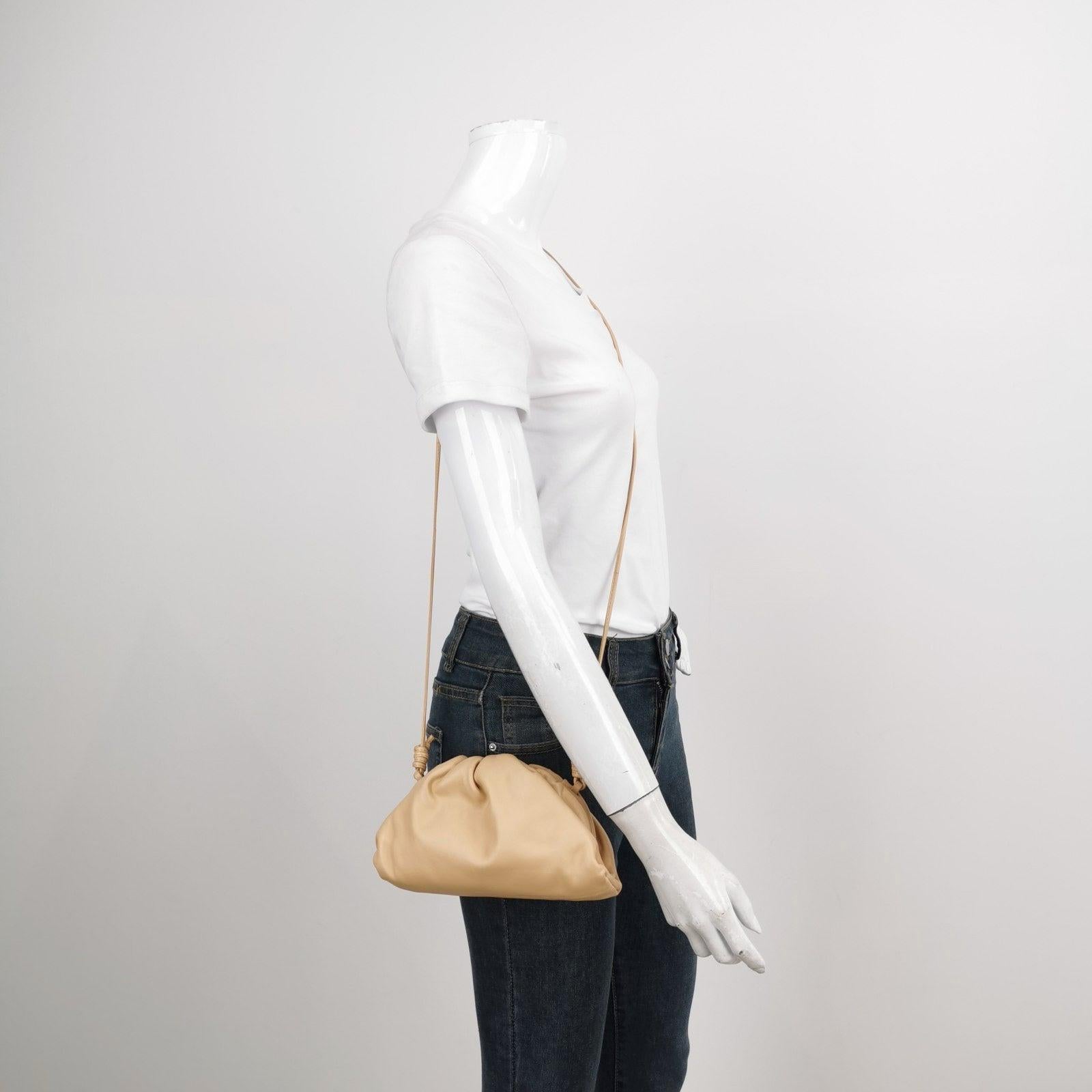Bottega Veneta Pouch Mini Beige Leather These are professional photos of the actual bag offered by Luxbags. Discover the sophisticated luxury of the Bottega Veneta Pouch Mini. Revel in its stylish cult design, handcrafted in a beige leather. Carry