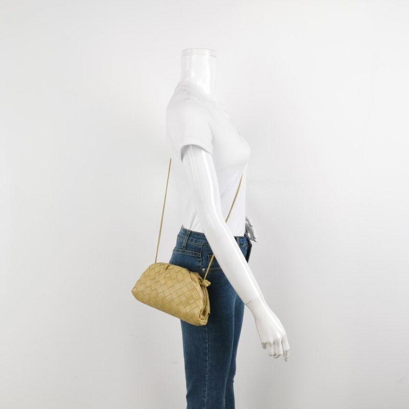 Bottega Veneta Pouch Mini Beige Leather
  These are professional photos of the actual bag.
  Discover the sophisticated luxury of the Bottega Veneta Pouch Mini. Revel in its stylish cult design, handcrafted in a beige leather. Carry it as a pouch,