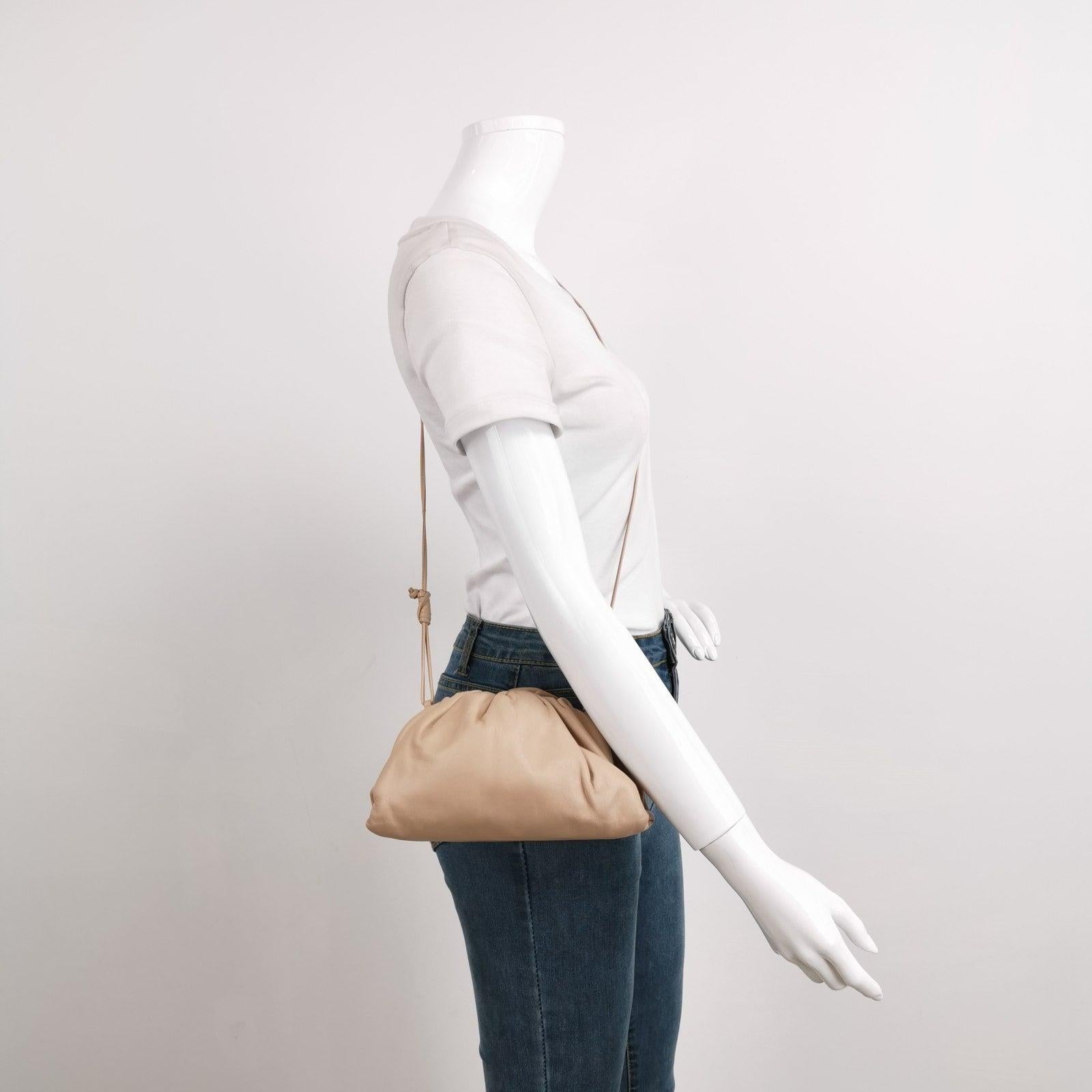 Bottega Veneta Pouch Mini Beige Nude Color Leather
  These are professional photos of the actual bag.
  Discover the sophisticated luxury of the Bottega Veneta Pouch Mini. Revel in its stylish cult design, handcrafted in a beige leather. Carry it as