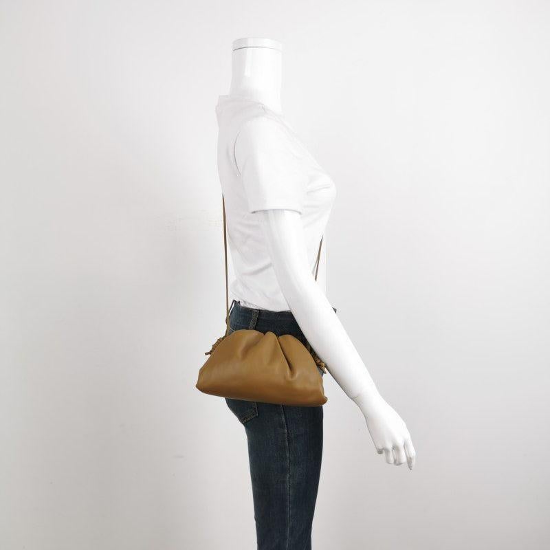 Bottega Veneta Pouch Mini Brown Leather
 These are professional photos of the actual bag.
 Discover the sophisticated luxury of the Bottega Veneta Pouch Mini. Revel in its stylish cult design, handcrafted in a brown leather. Carry it as a pouch,