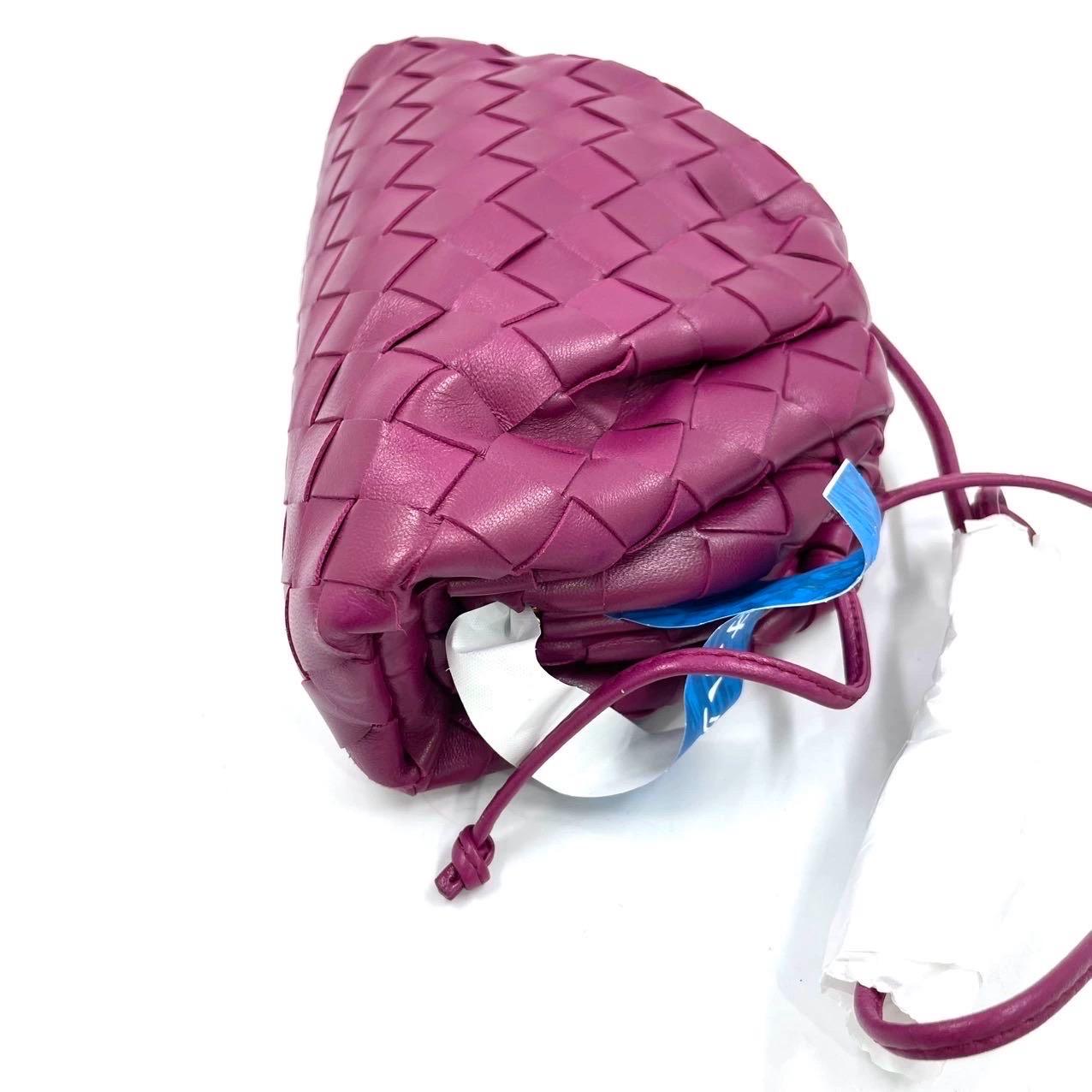 Bottega Veneta Pouch Mini Intrecciato Burgundy Lambskin Leather Crossbody Bag These are professional photos of the actual bag offered by Luxbags. Discover the sophisticated luxury of the Bottega Veneta Pouch Mini. Revel in its stylish cult design,