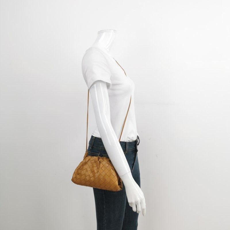 Bottega Veneta Pouch Mini Intrecciato Camel Lambskin Leather Crossbody Bag
These are professional photos of the actual bag.
  Discover the sophisticated luxury of the Bottega Veneta Pouch Mini. Revel in its stylish cult design, handcrafted in a