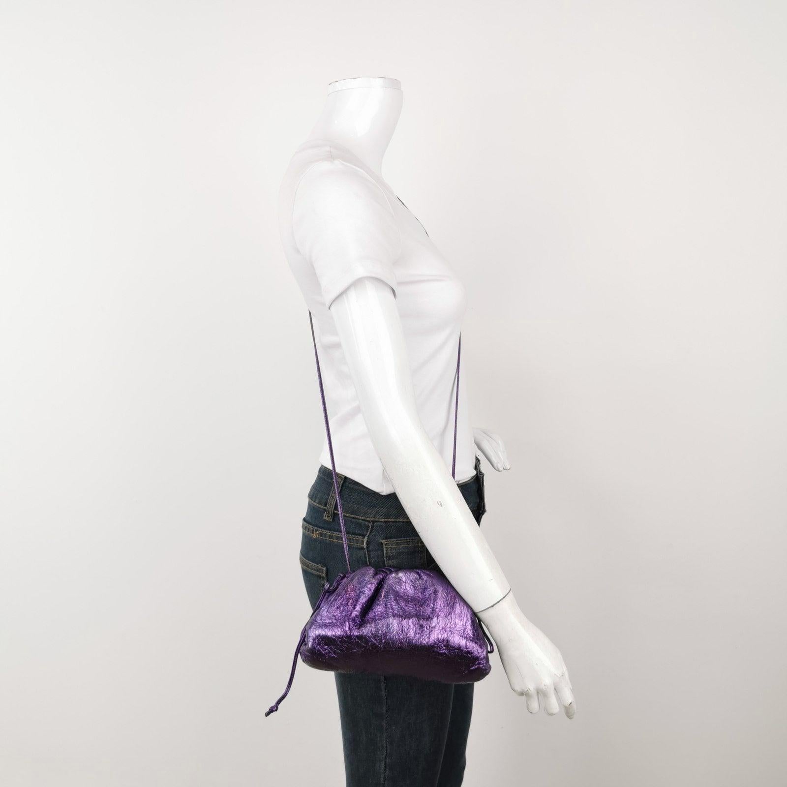 Bottega Veneta Pouch Mini Metallic Purple Leather These are professional photos of the actual bag offered by Luxbags. Discover the sophisticated luxury of the Bottega Veneta Pouch Mini. Revel in its stylish cult design, handcrafted in a charming