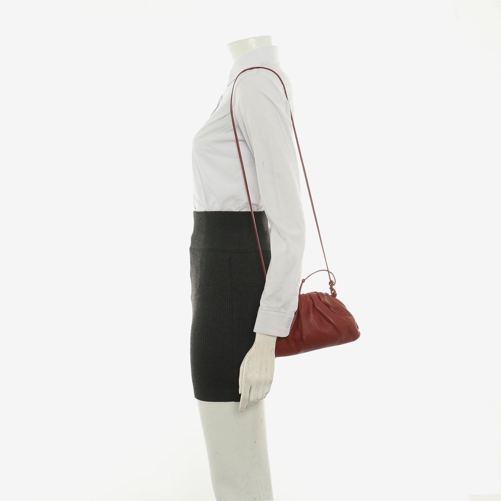 Bottega Veneta Pouch Mini Red Leather
 These are professional photos of the actual bag.
 Discover the sophisticated luxury of the Bottega Veneta Pouch Mini. Revel in its stylish cult design, handcrafted in a luxurious burgundy calfskin leather with