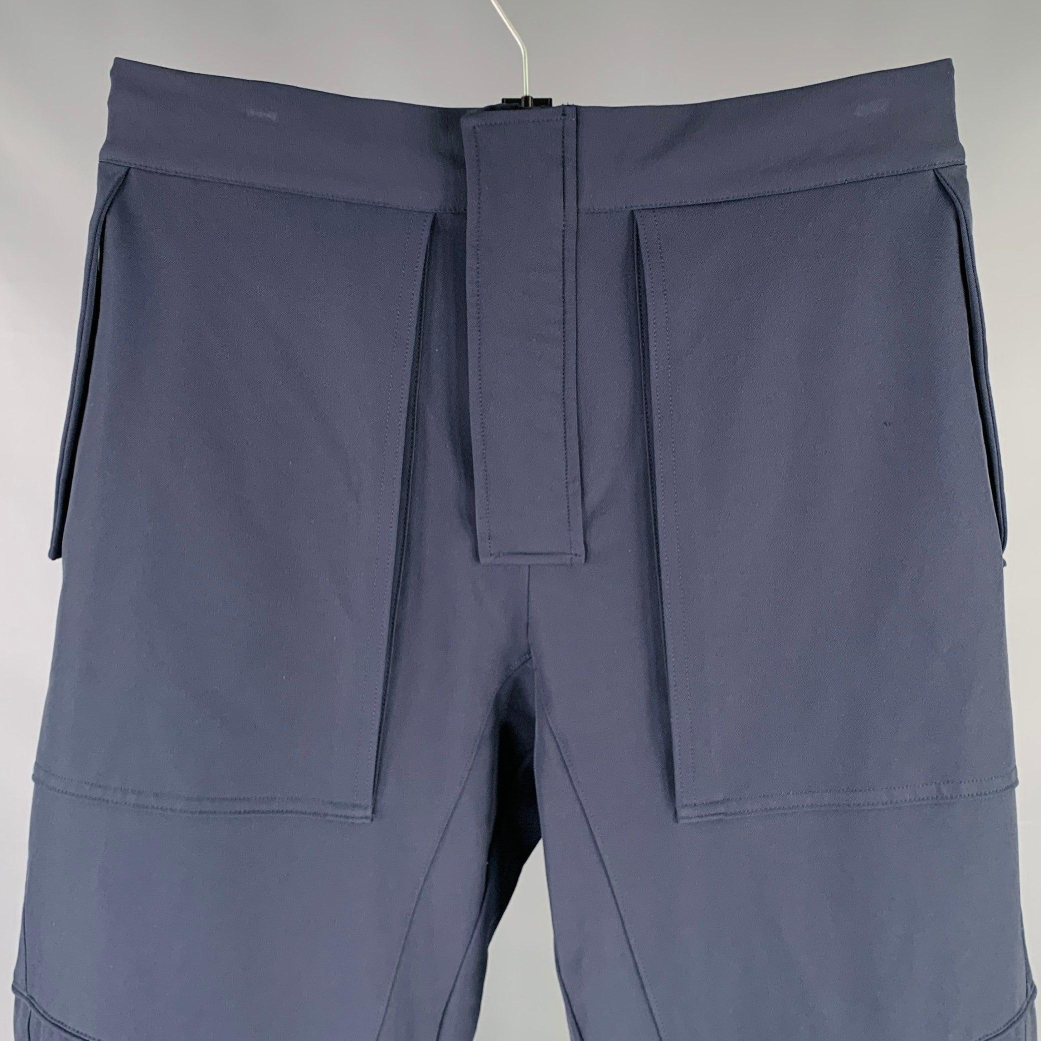 BOTTEGA VENETA by DANIEL LEE Pre-Fall 2019 casual pants
in a navy polyamide stretch blend fabric featuring a relaxed fit, multiple zip pockets, and zip fly closure with drawstring waistband. Made in Italy.Excellent Pre-Owned Condition. 

Marked:  