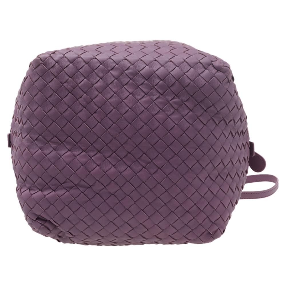 This bag from Bottega Veneta is crafted from purple Intrecciato leather using their signature Intrecciato weaving technique flaunting a seamless silhouette. This bag, personifying elegance and subtle charm, is held by a long shoulder strap. Brimming