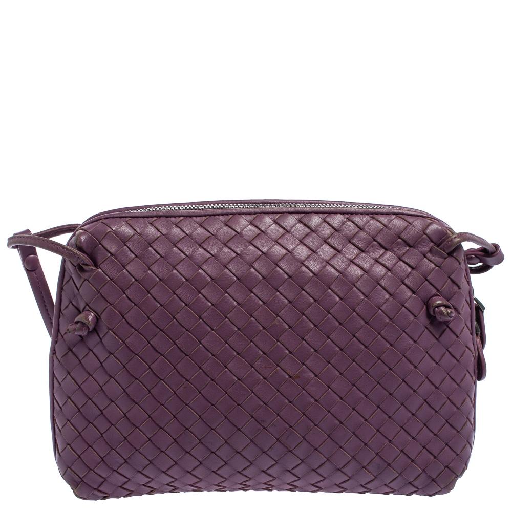 This Nodini bag from Bottega Veneta is crafted from purple leather using their signature Intrecciato weaving technique flaunting a seamless silhouette. Brimming with artistry and quality craftsmanship, the bag has an interior that is spacious enough