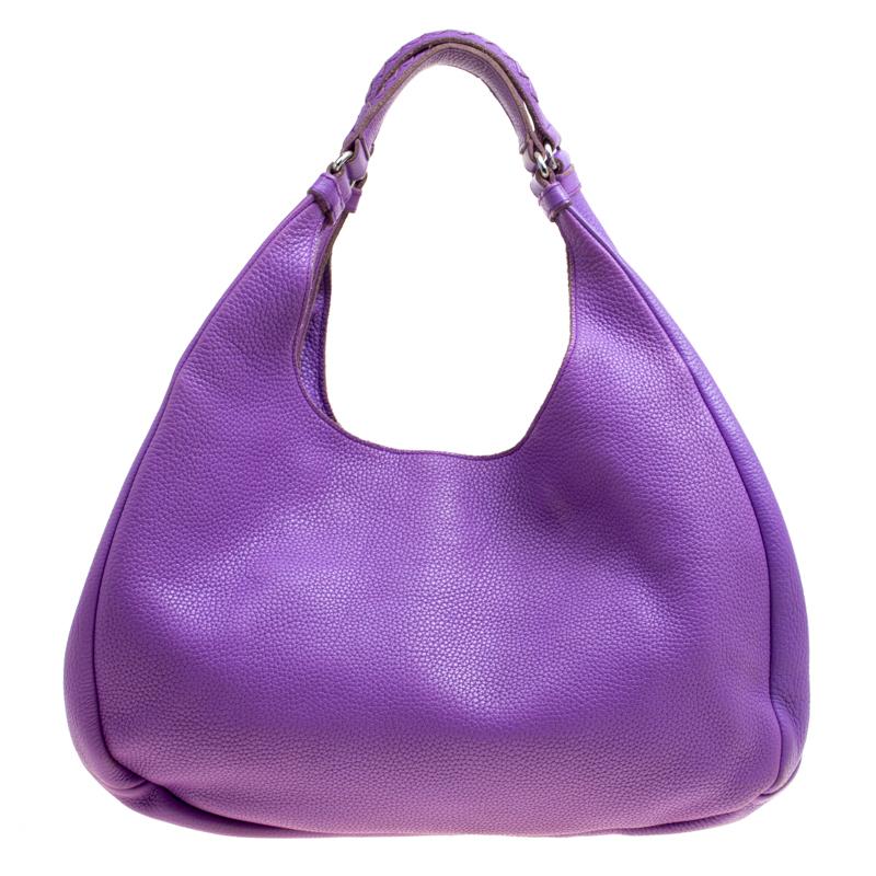If you like to keep it minimal yet chic, go for this brightly-colored Bottega Veneta hobo. Crafted with feminine-looking purple-colored leather featuring a smooth finish. The exterior of the bag is equipped with two top handles accented with the
