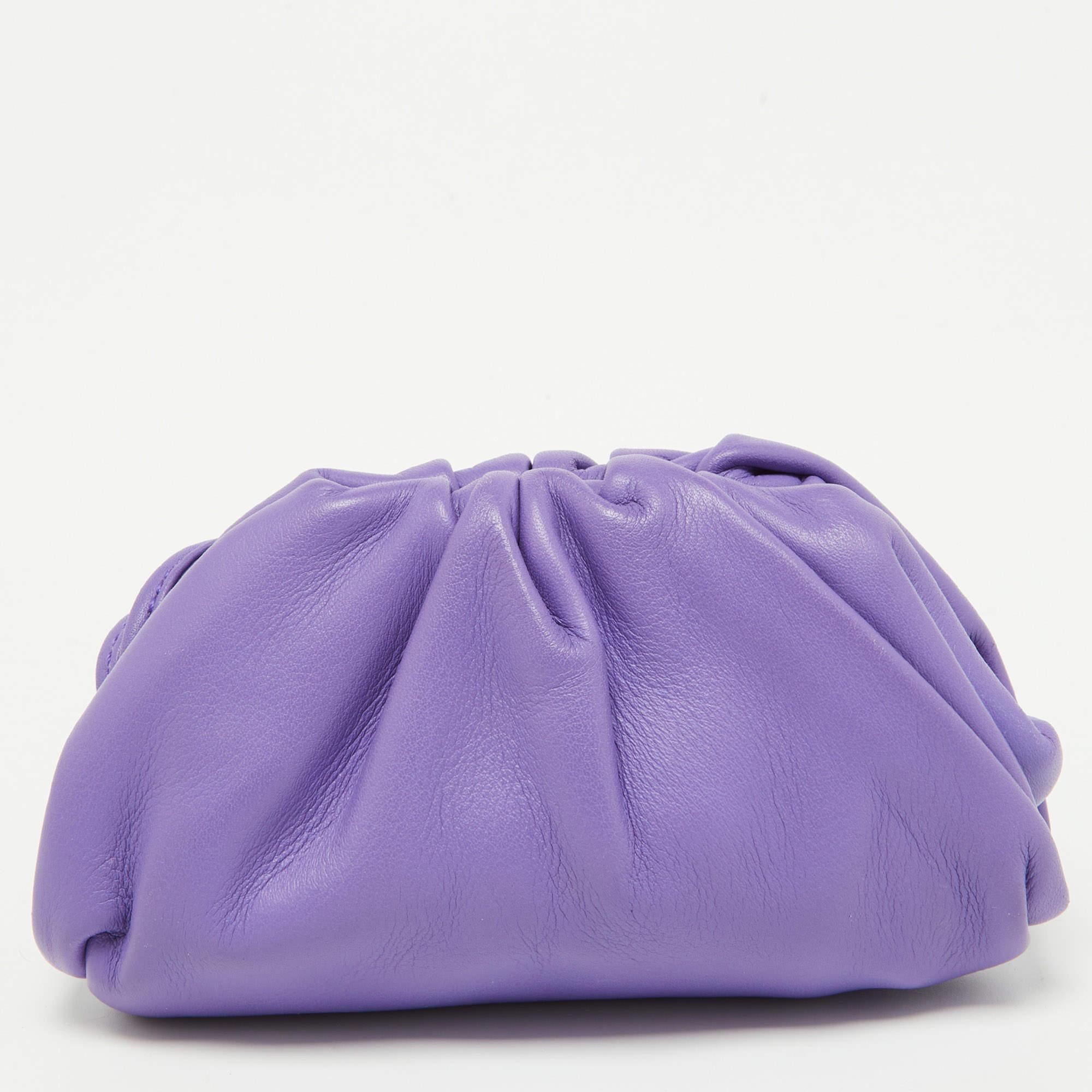 Made from supple purple leather, it features a sleek, minimalist design with a secure zip closure. The compact size makes it perfect for storing coins and small essentials while adding a touch of elegance to your ensemble.

