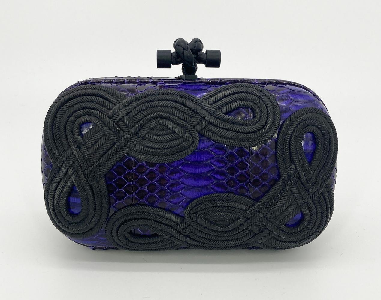 Bottega Veneta Purple Snakeskin Knot Clutch in excellent condition. Purple snakeskin exterior trimmed with distressed black rope embroidery along front and back side. Matte black top knot lift latch closure opens to a brown suede interior. Overall