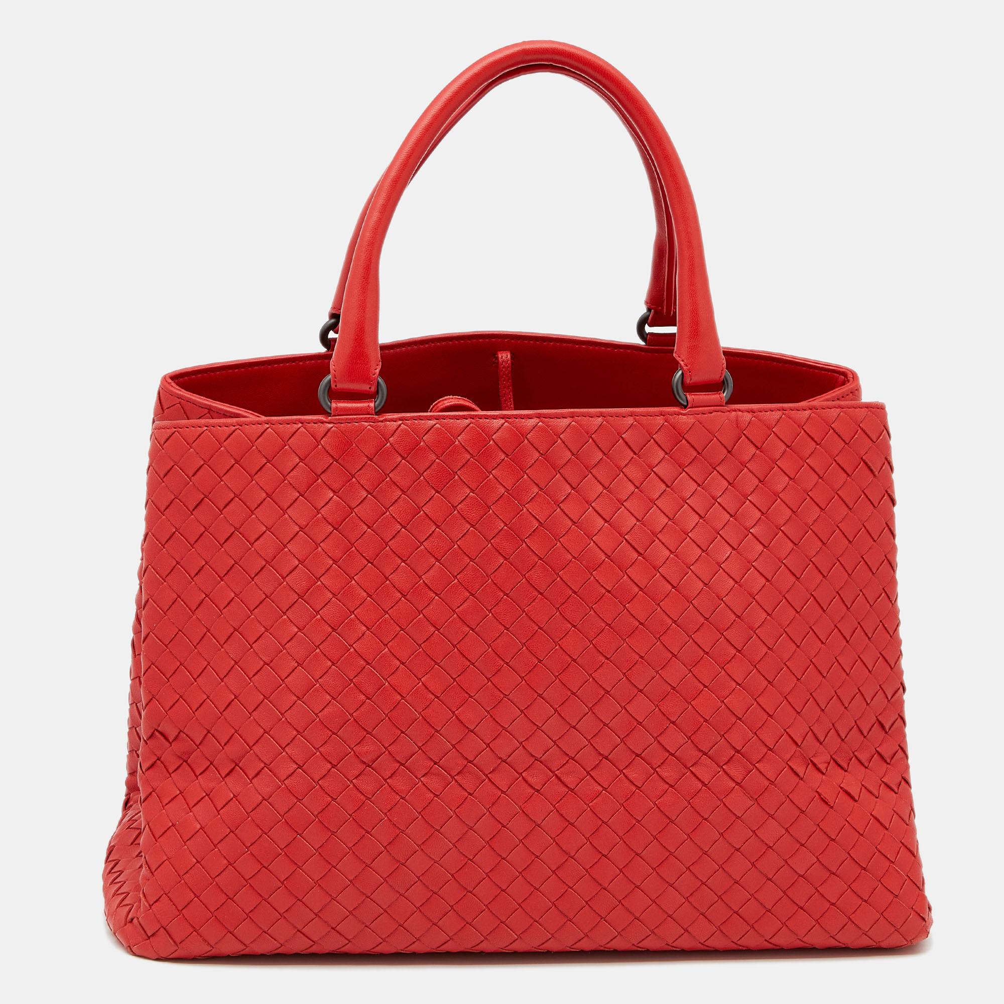 This Bottega Veneta tote is a timeless piece that can last you season after season. This bag is made of Intrecciato leather and will suit all your needs. It has a red shade, black-tone hardware, dual handles, and a suede-lined interior.

Includes: