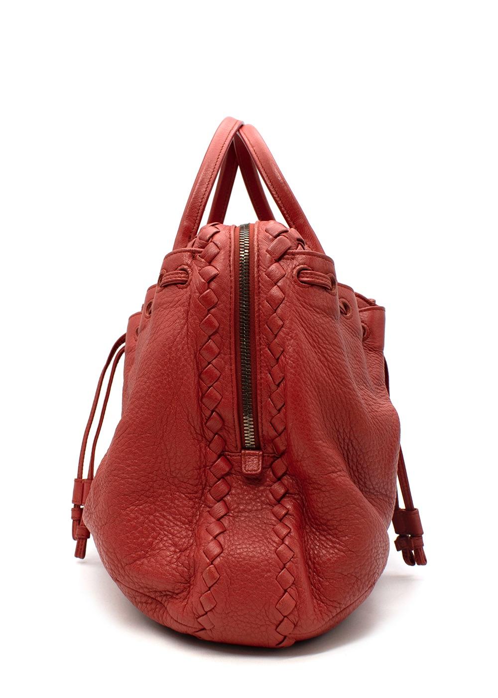 Bottega Veneta Red Leather Intrecciato Bag

- Signature woven Intrecciato red leather panel at the top of the bag 
- Gathered, drawstring body
- Suede interior 

Materials:
Leather
Suede 

Made in Italy 

PLEASE NOTE, THESE ITEMS ARE PRE-OWNED AND