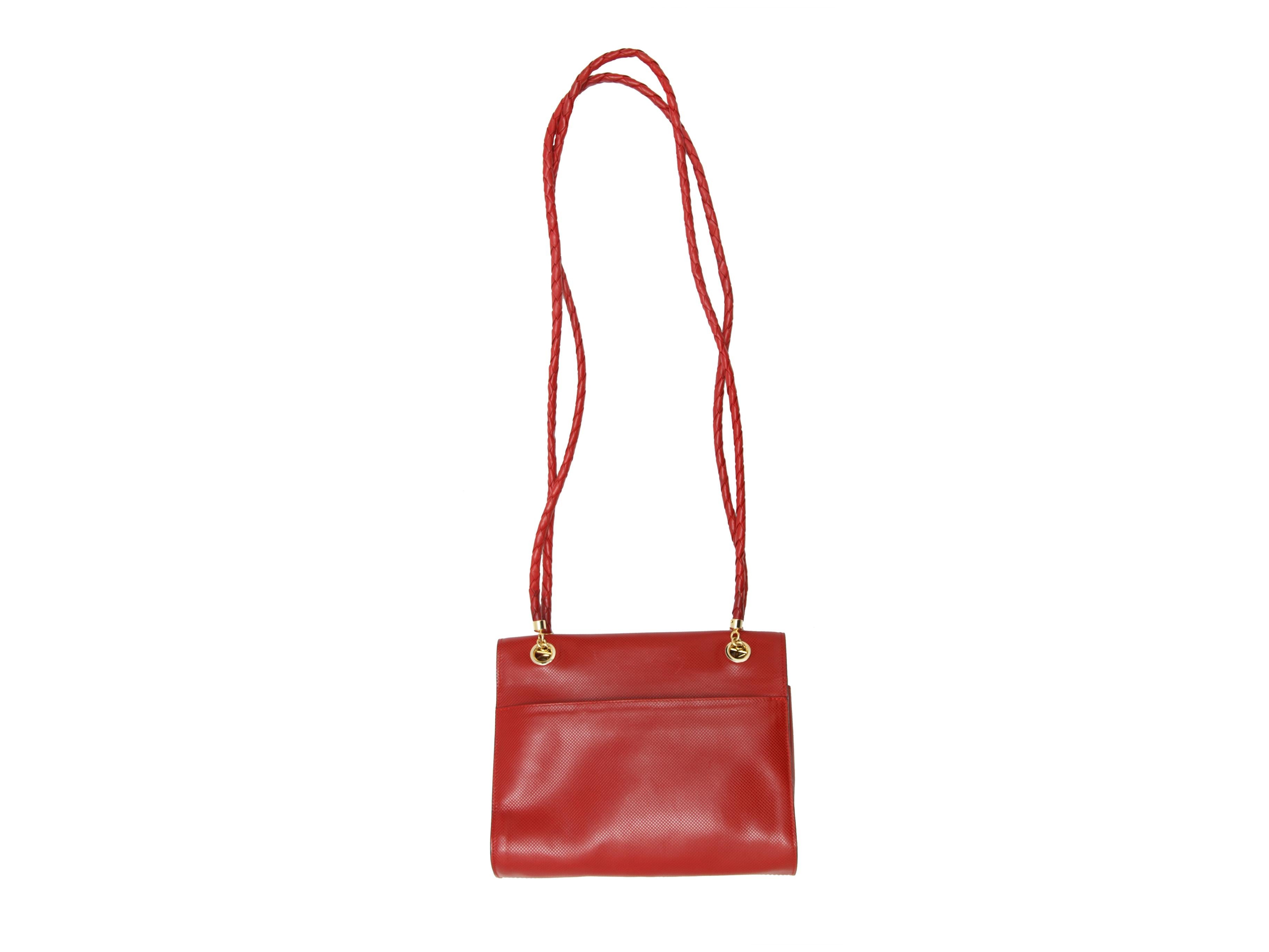 Product details: Red leather Marco Polo bag by Bottega Veneta. Gold-tone hardware. Detachable intrecciato straps. Interior zip pocket. Open pocket at back. Turn-lock closure at front. 9.5