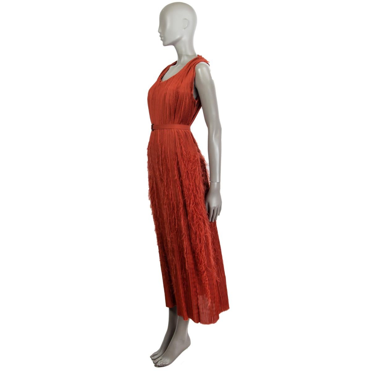 100% authentic Bottega Veneta plisse feather maxi dress in rust polyester (100%) with a round neck. Has two hidden slit pockets on each side. Comes with a matching belt and a black buckle. Closes on the side with a zipper. Partially lined. Second